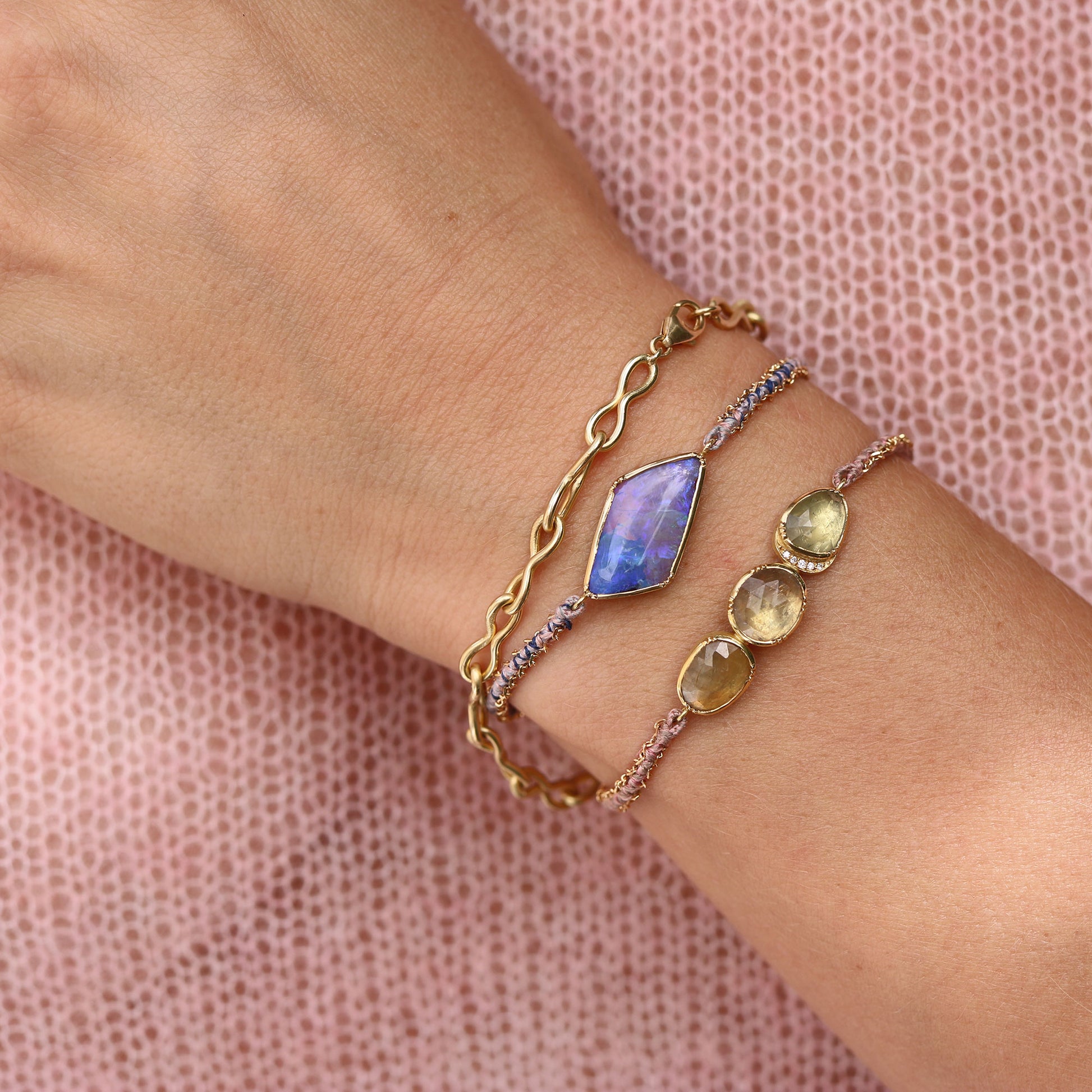 Model wearing One of a kind bracelet with Opal with hand woven silk and 18k gold chain bracelet from Los Angeles jewelry designer Brooke Gregson.