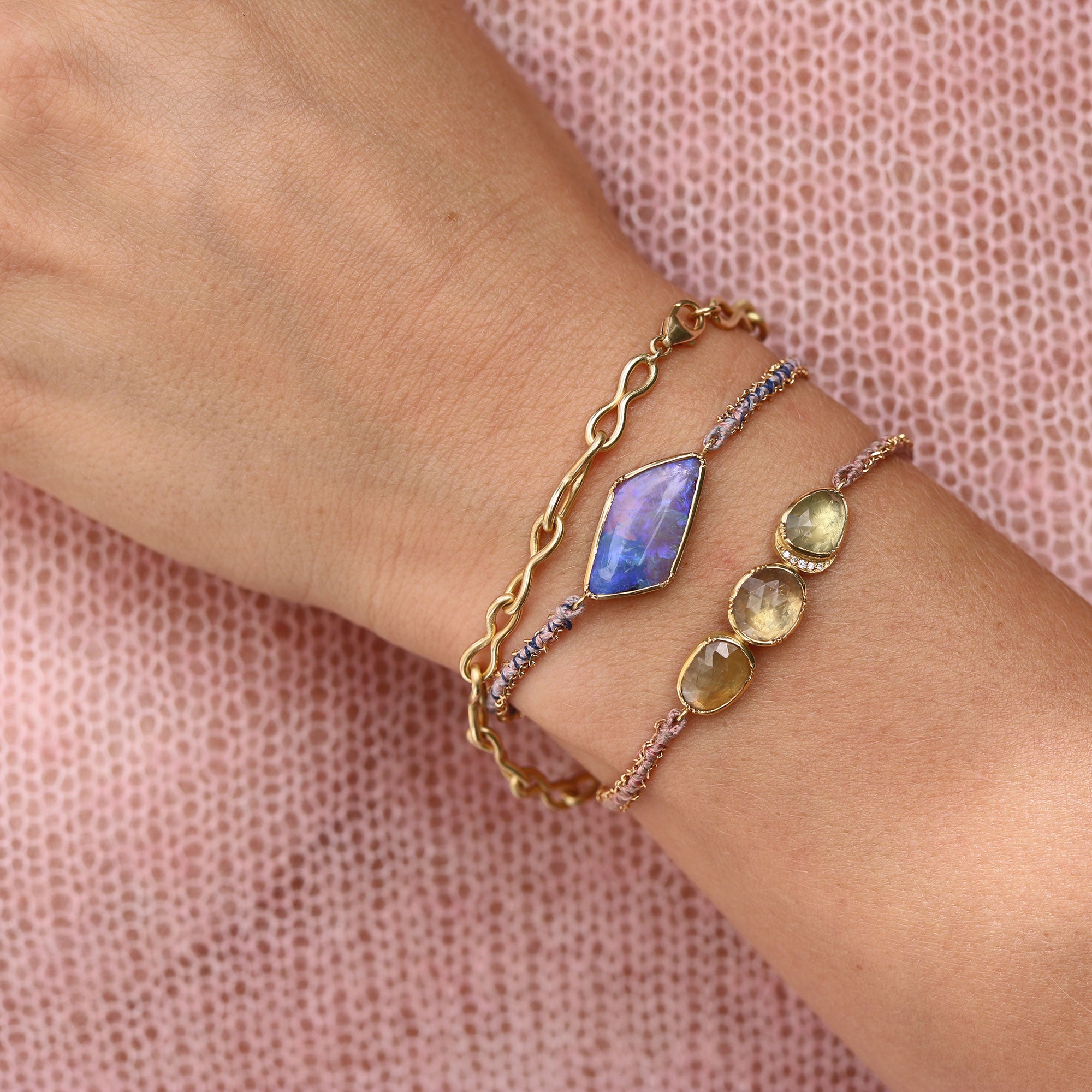 Model wearing One of a kind bracelet with Opal with hand woven silk and 18k gold chain bracelet from Los Angeles jewelry designer Brooke Gregson.