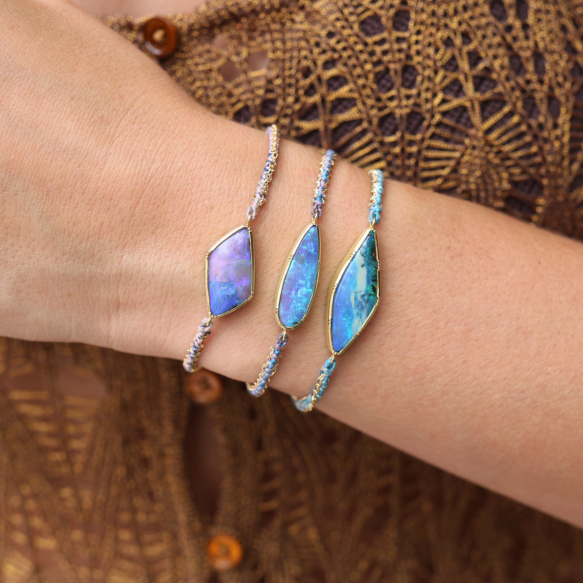 Model wearing one of a kind Boulder Opal bracelets with hand woven silk and 18k gold chain bracelet from Los Angeles jewelry designer Brooke Gregson.