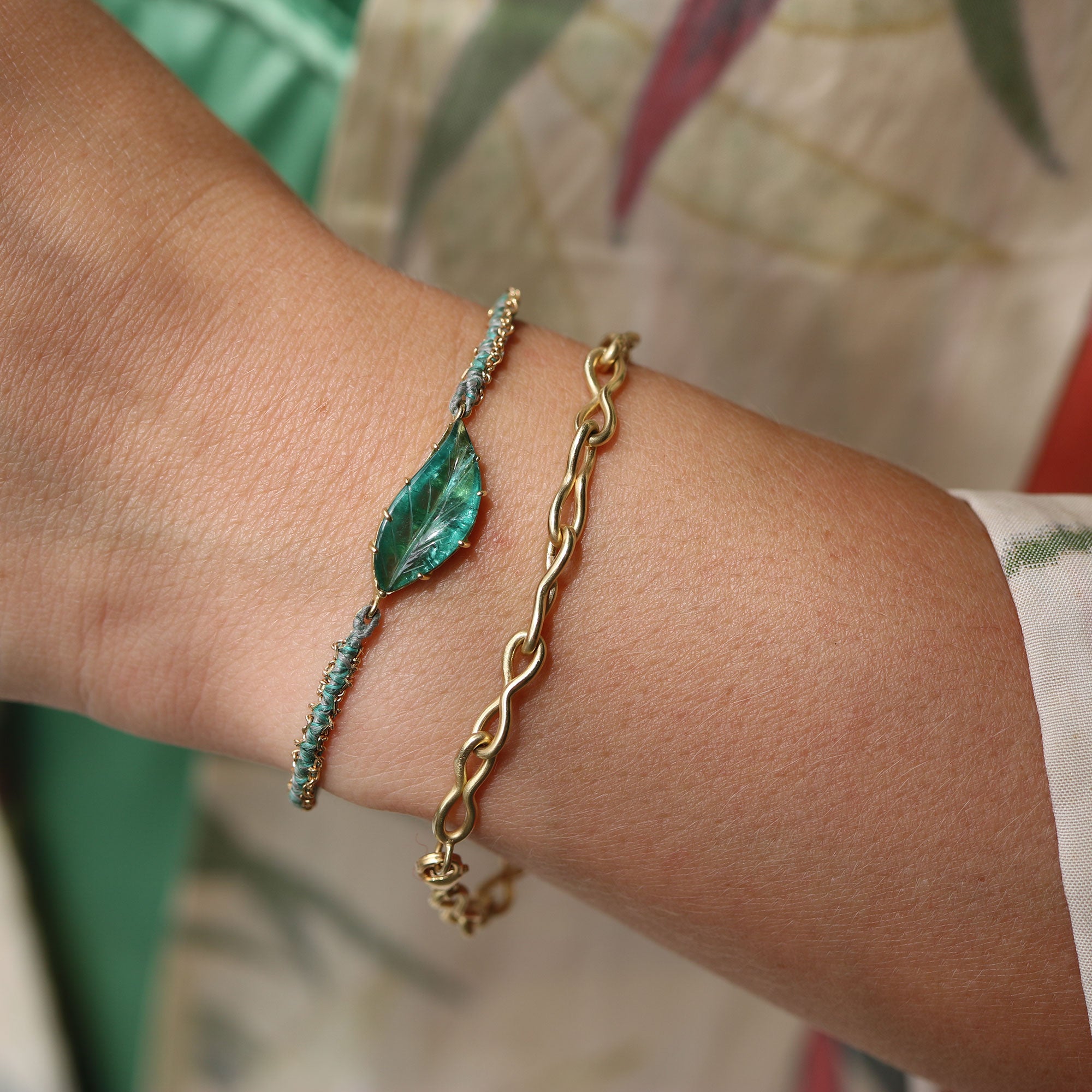 Model wearing one of a kind 18k gold green Tourmaline leaf bracelet with hand woven silk and 18k gold chain from Los Angeles jewelry designer Brooke Gregson.