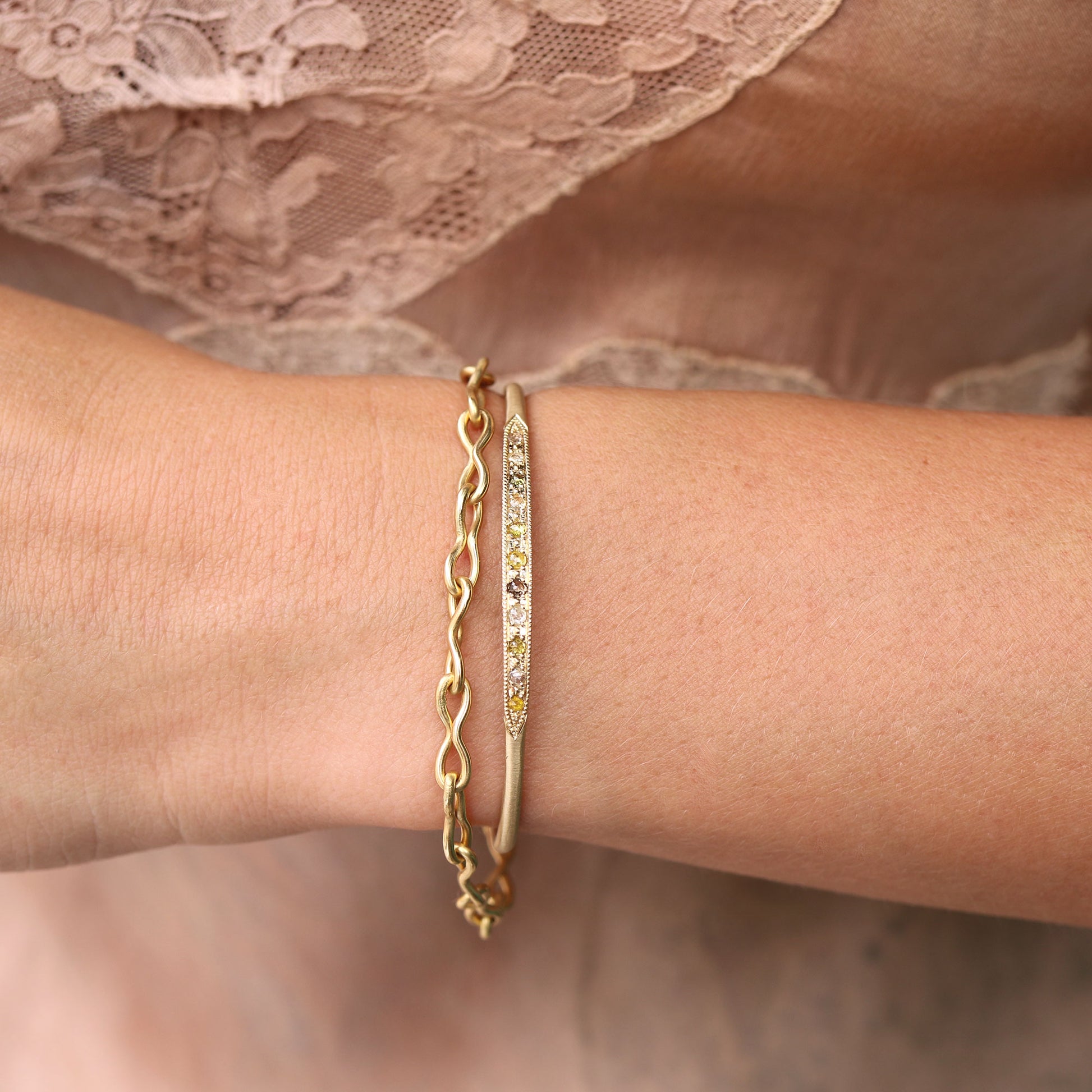 Model wearing 14k gold mixed champagne, yellow and cognac diamond cuff and 18k gold chain bracelet from Brooke Gregson handmade in Los Angeles.