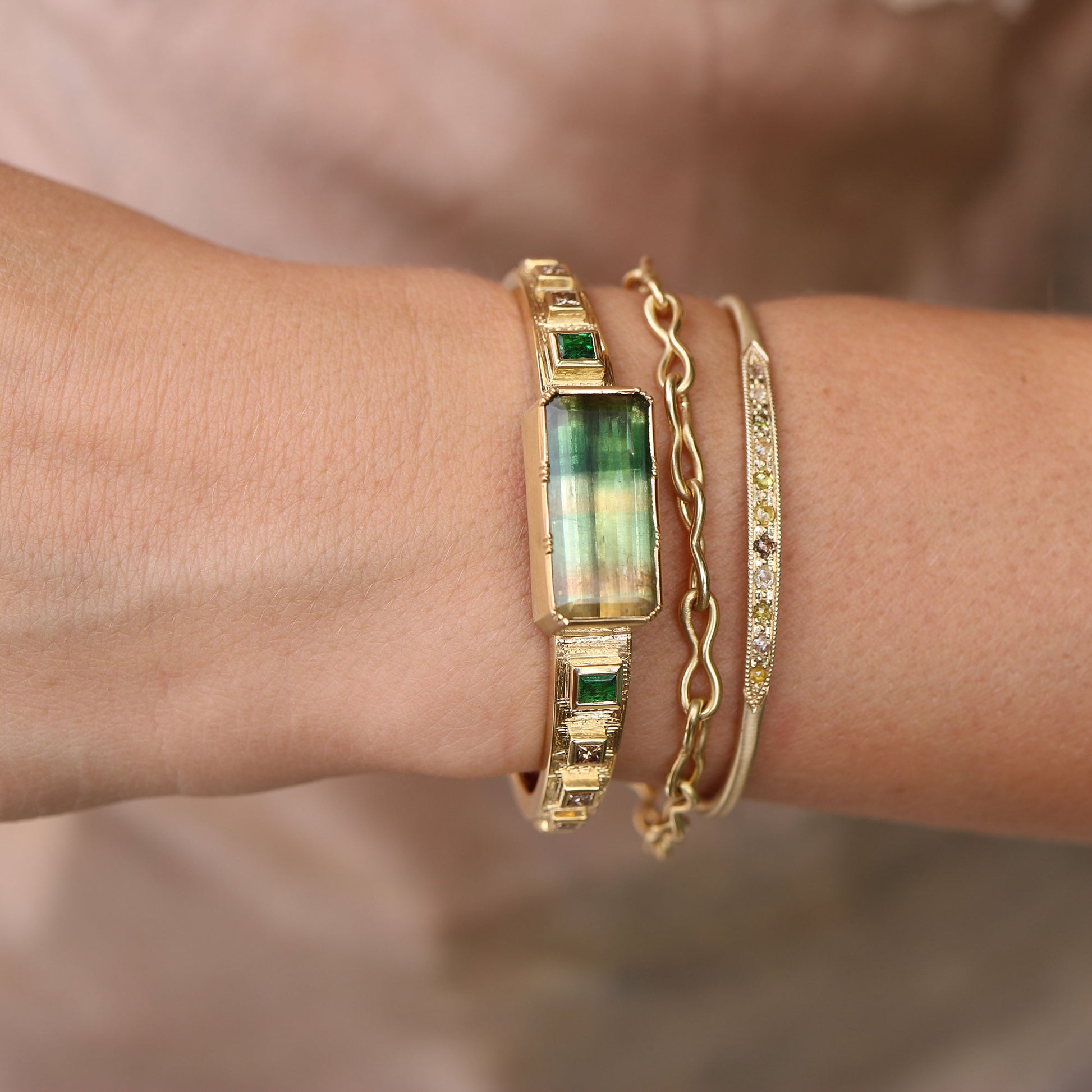Model wearing one of a kind bi-color Tourmaline 18k gold hand engraved cuff with Diamond and Tourmaline, fine jewelry handmade in London from Los Angeles designer Brooke Gregson.