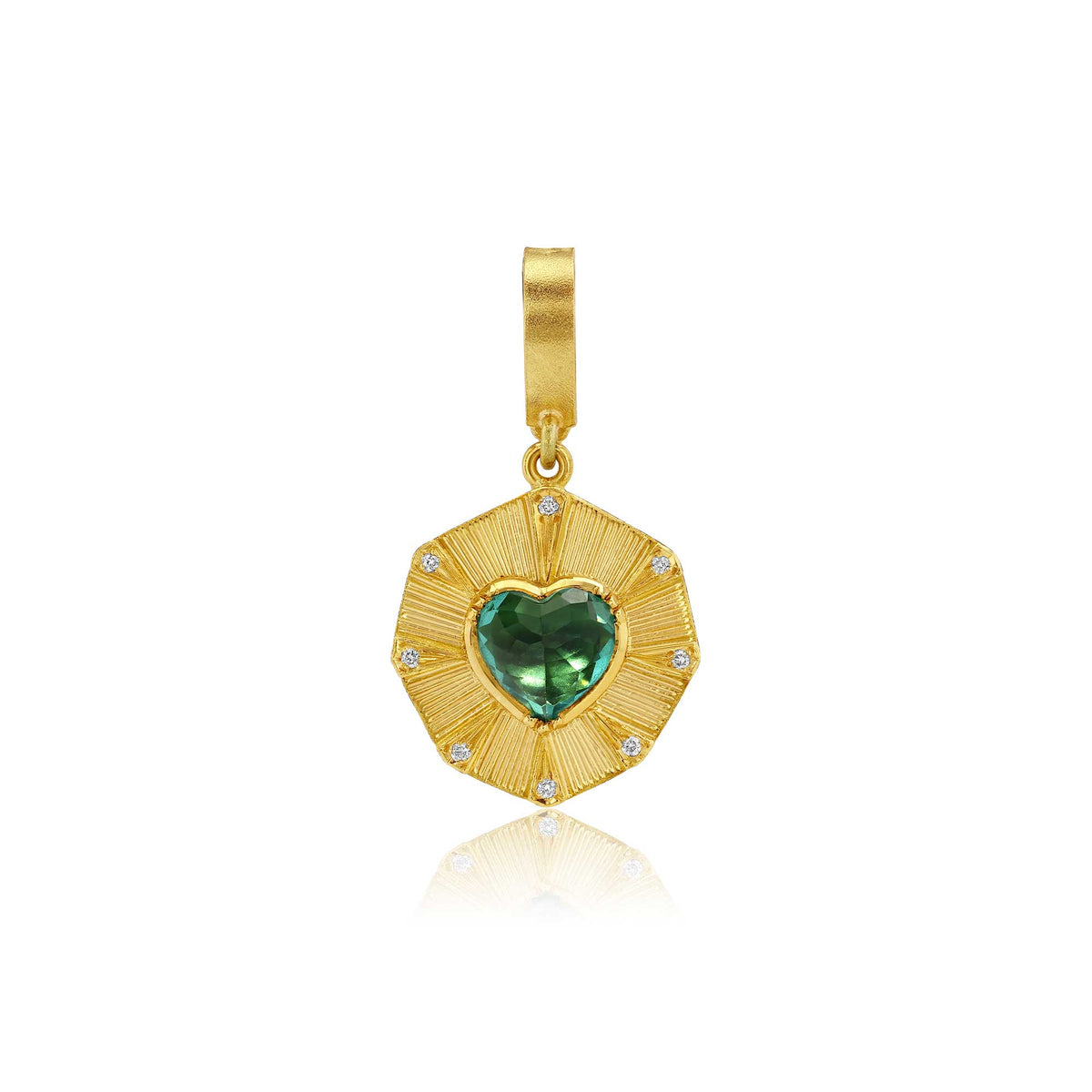 A gold pendant featuring a textured sunburst design with a central green heart-shaped tourmaline gemstone and small clear diamond stones, shown on a white background with a soft reflection.