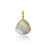 A gold pendant featuring a scallop shell with iridescent mother-of-pearl inlay and a row of small clear stones along the top, shown on a white background with a soft reflection below.