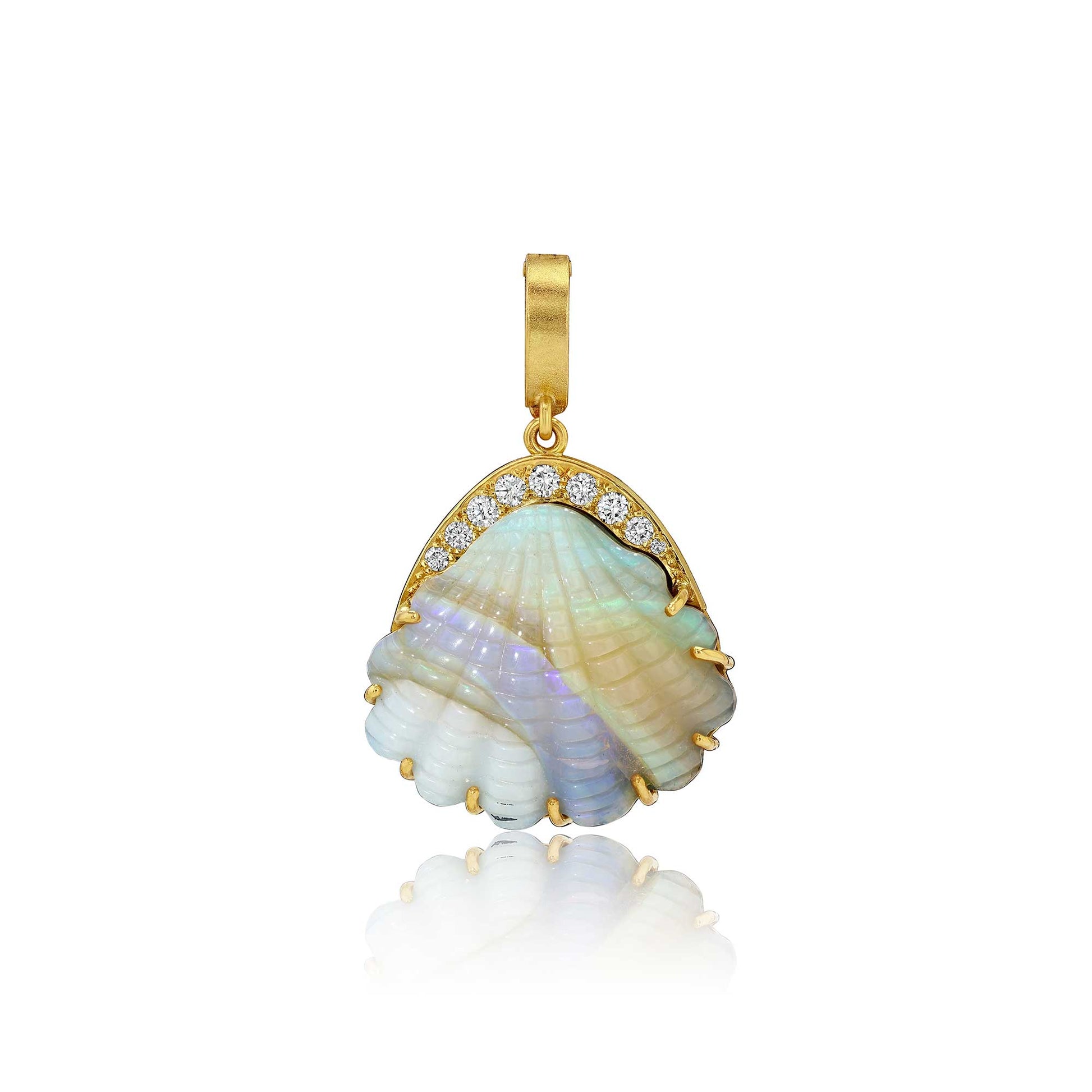 A gold pendant featuring a scallop shell with iridescent mother-of-pearl inlay and a row of small clear stones along the top, shown on a white background with a soft reflection below.