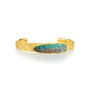 Gold engraved cuff bracelet with a Boulder Opal stone on a white background