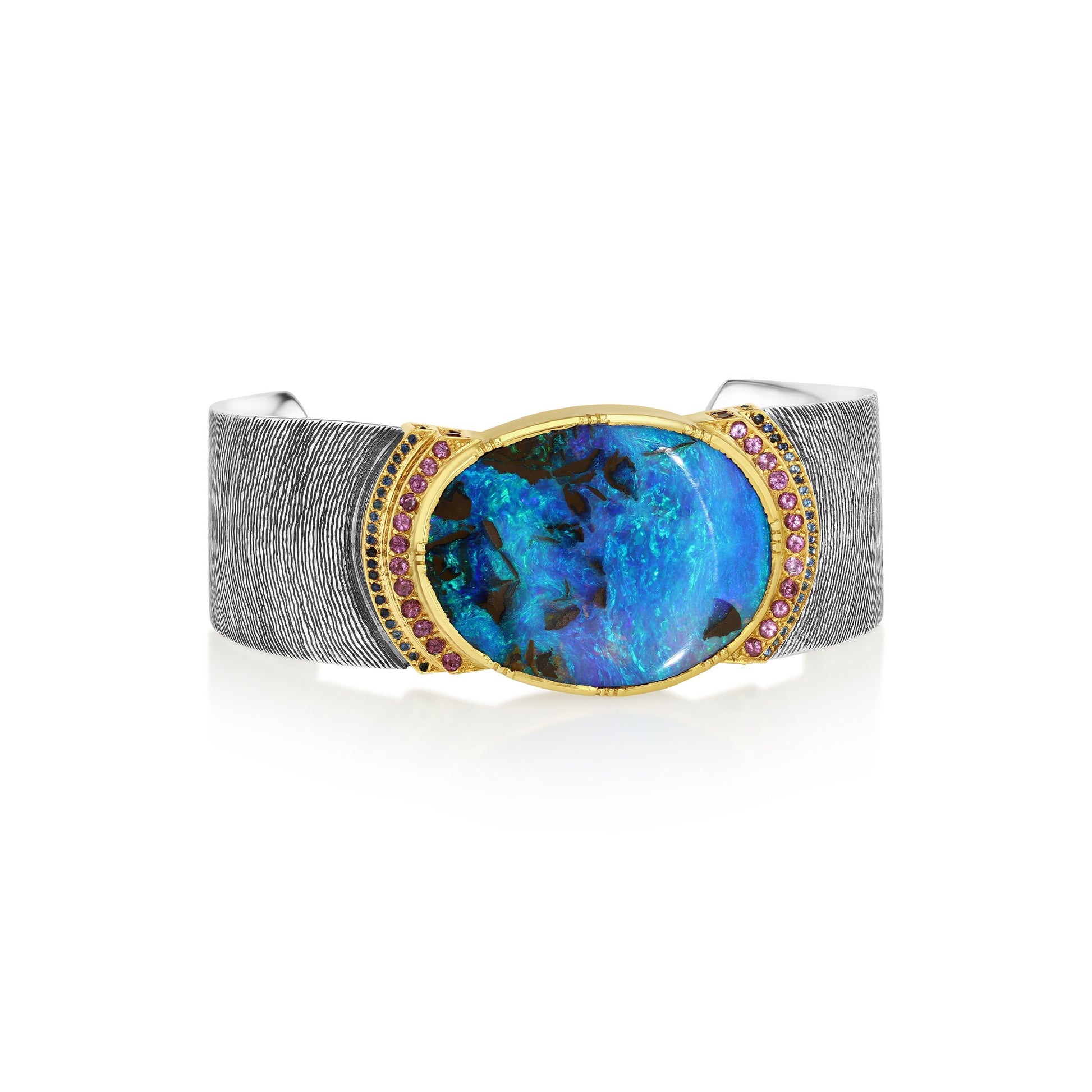 Sterling Silver and 18k gold hand engraved cuff with blue opal gemstone and pink spinel and sapphire stones on a white background