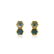 Pair of hexagonal blue sapphire gemstone earrings with gold accents on a white background