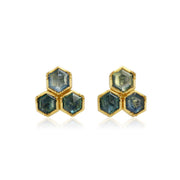 Hexagonal blue sapphire gemstone earrings with gold setting on a white background