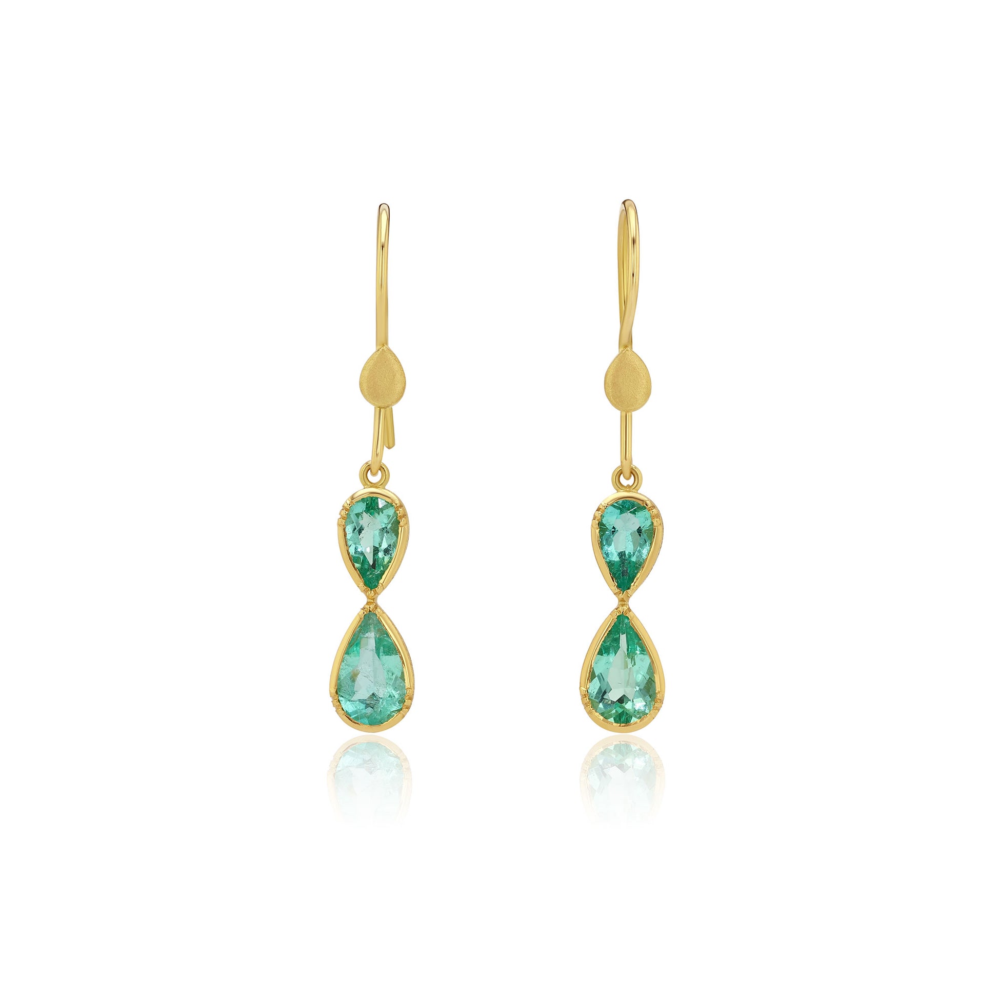 Gold earrings with emerald gemstones in an infinity shape on a white background