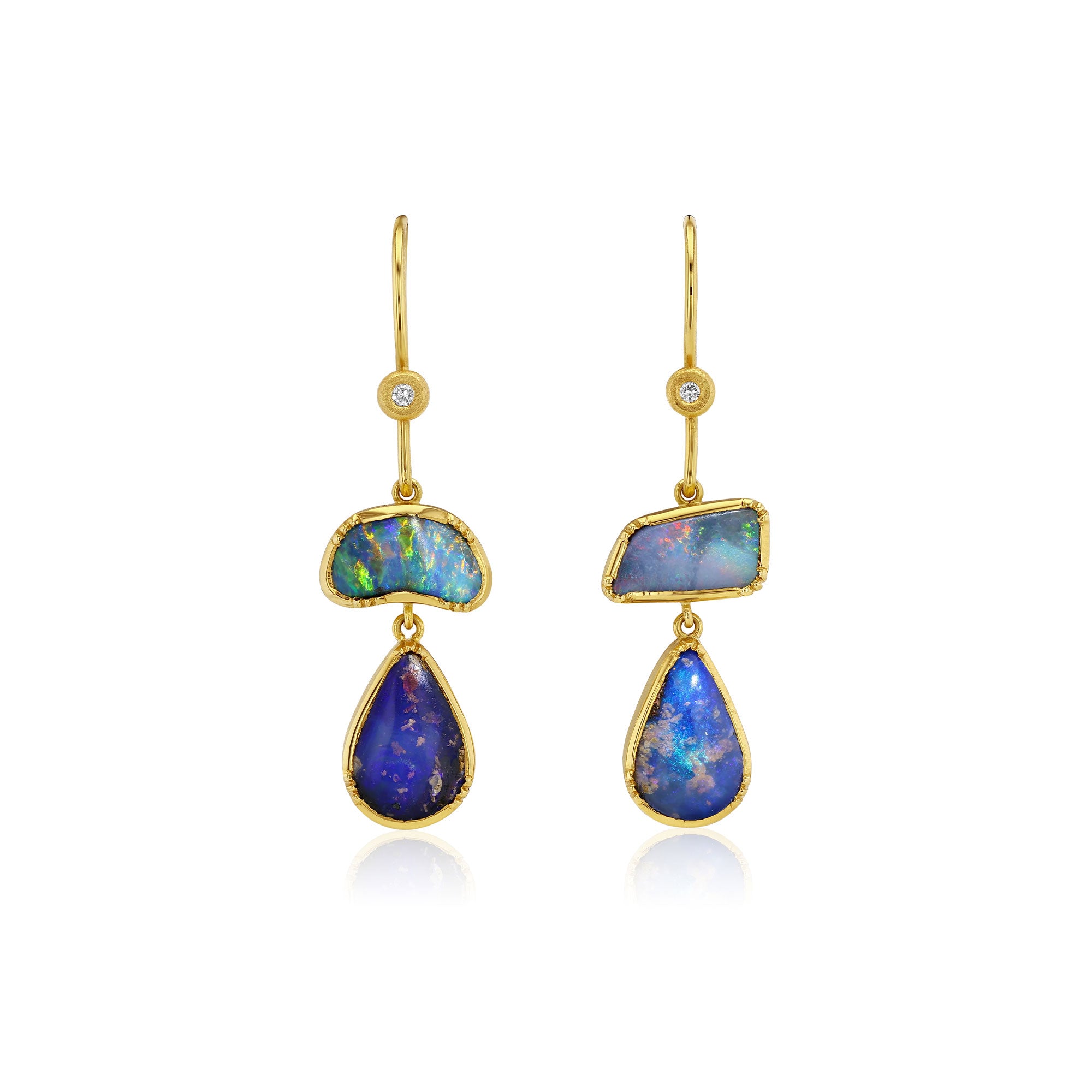 A pair of gold drop earrings featuring irregular blue opal stones and teardrop-shaped blue opal drops, each accented with a small clear stone near the hook, shown on a white background.