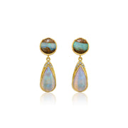 A pair of gold drop earrings featuring round cabochon opal stones at the top and teardrop-shaped opal drops below, accented with small clear stones, set against a plain white background.