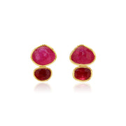 Pair of gold earrings with pink sapphire gemstones on a white background