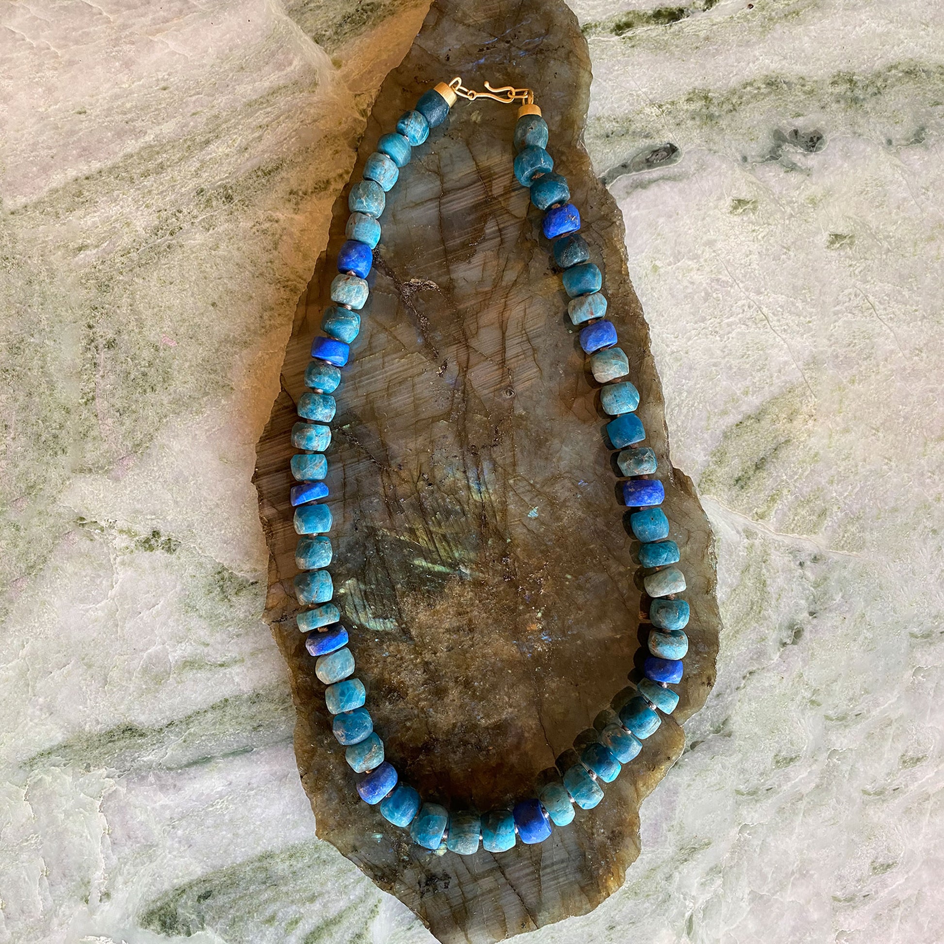 Necklace with blue beads on a stone surface