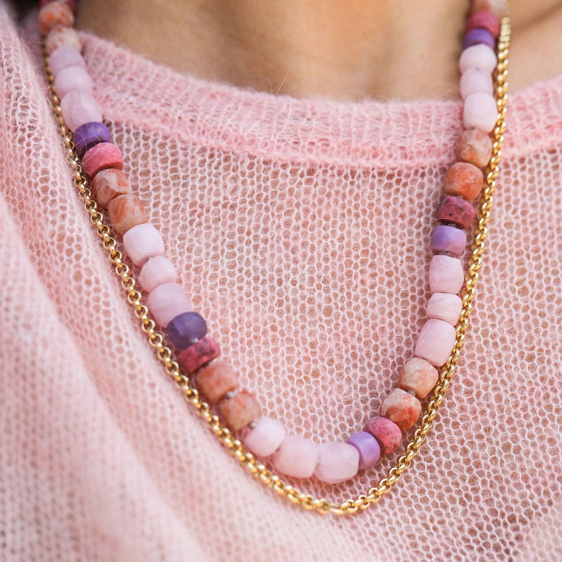 pink beads worn with a gold chain on a pink jumper by brooke gregson.