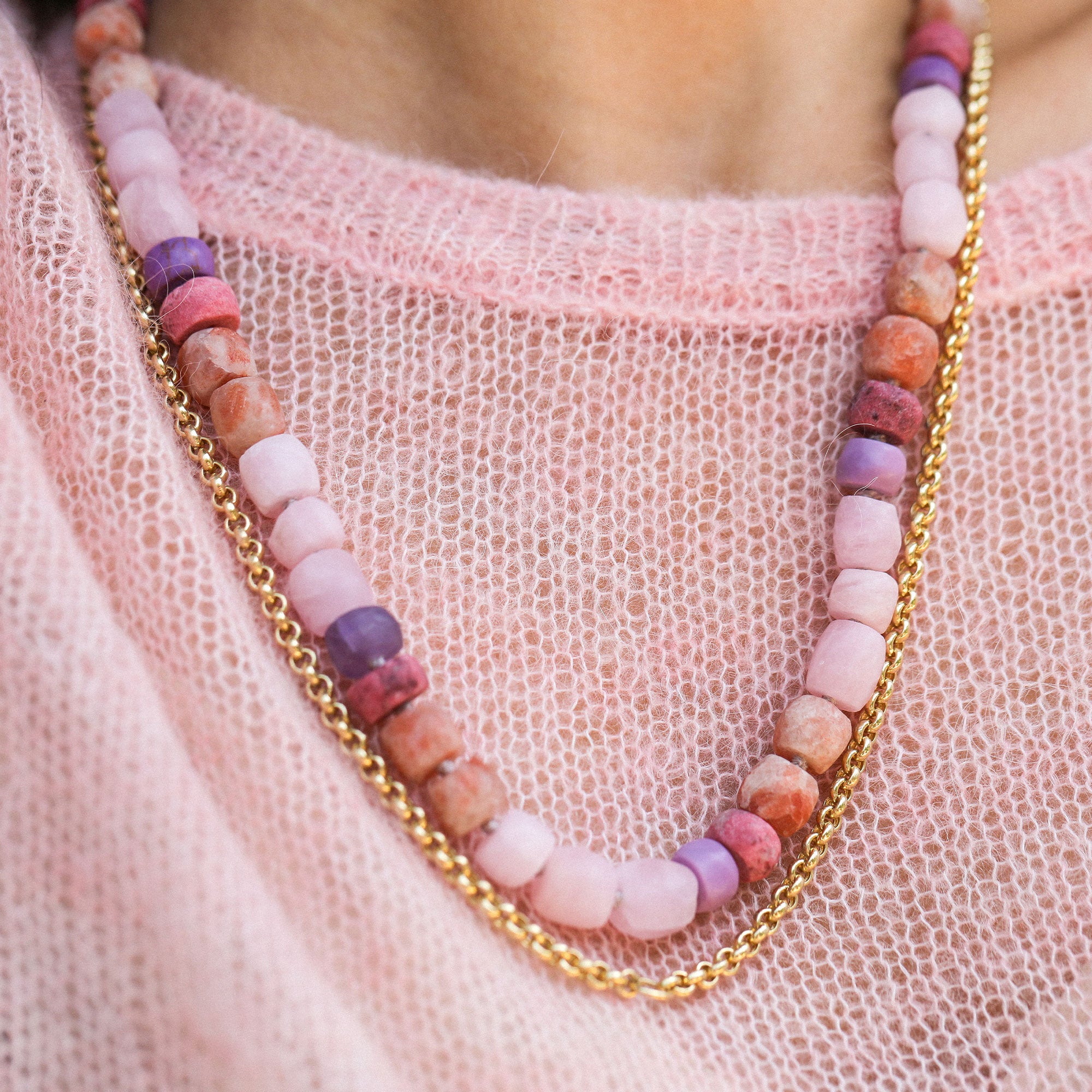 pink beads worn with a gold chain on a pink jumper by brooke gregson.