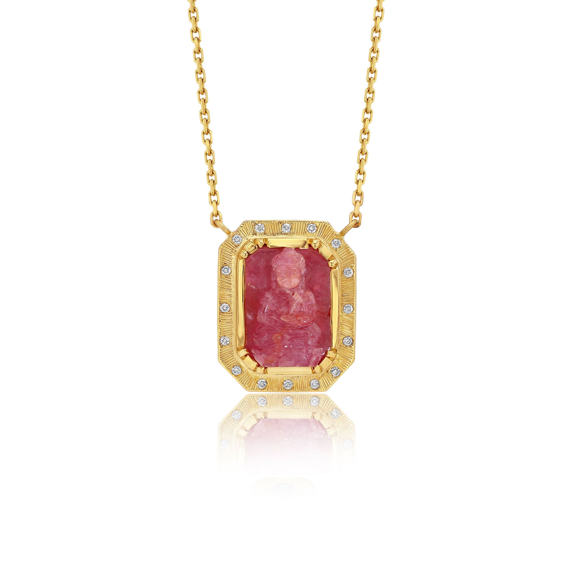 Gold necklace with a red ruby buddah gemstone pendant on a white background