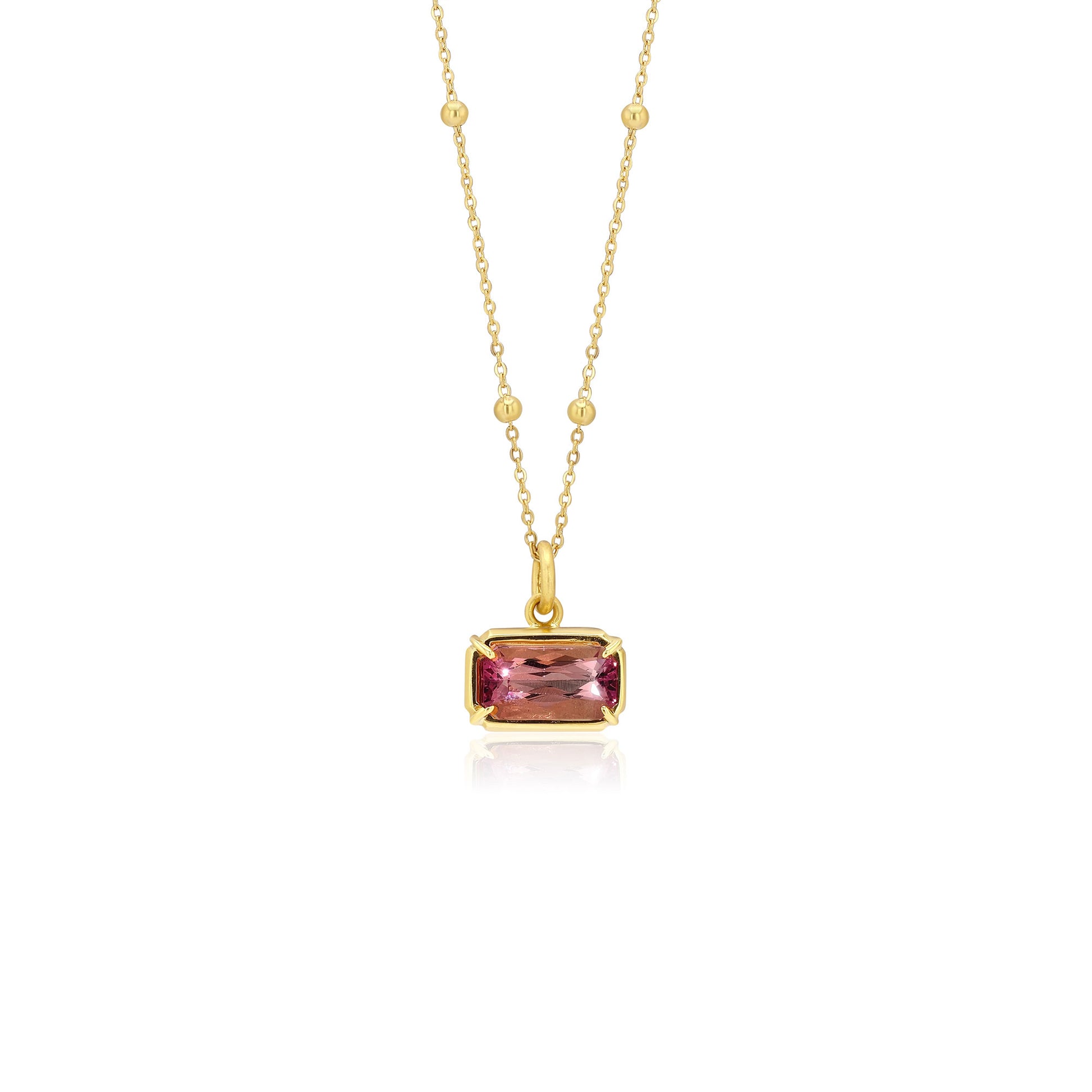 18K Gold necklace with a pink tourmaline gemstone pendant on a white background