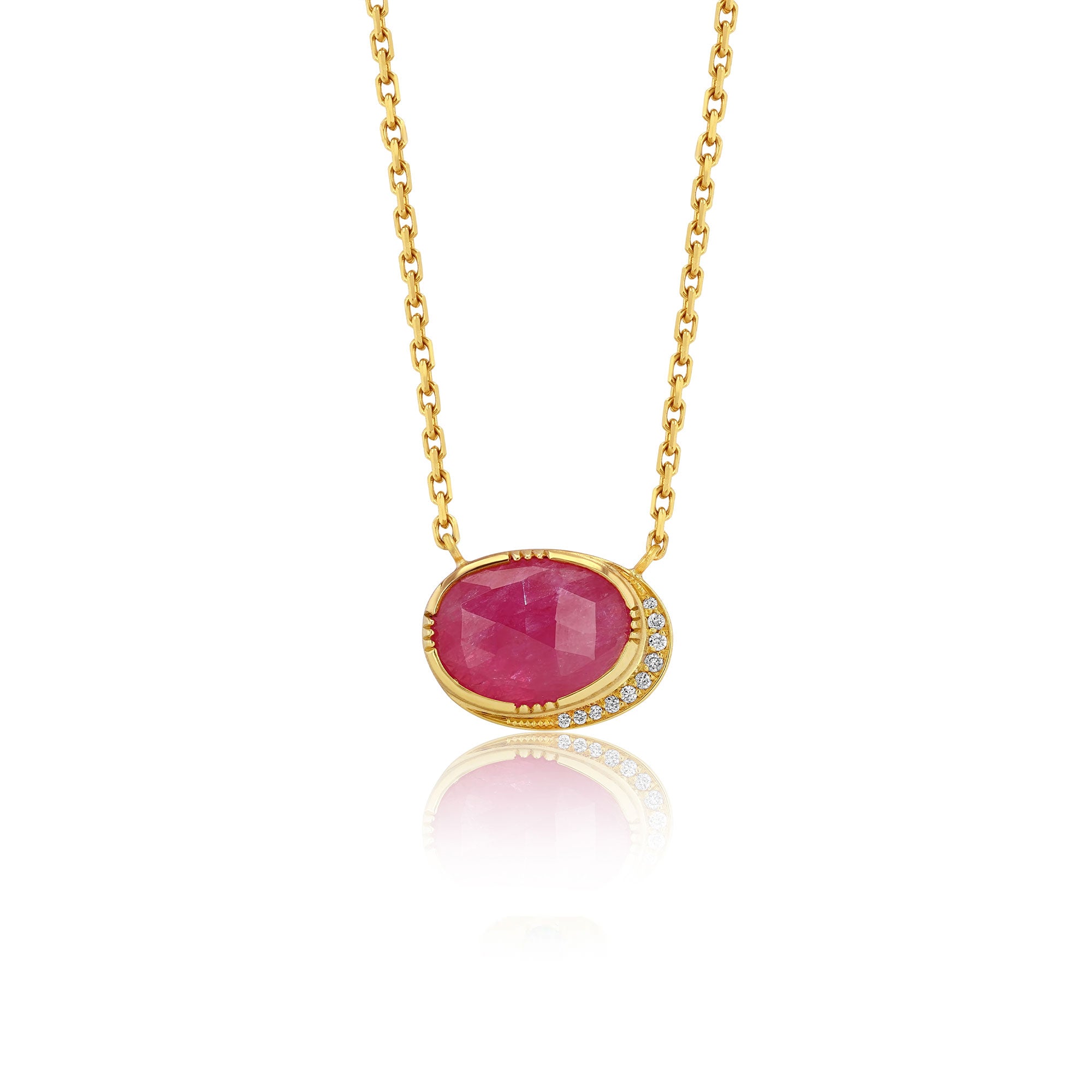Gold necklace with a red ruby gemstone pendant on a white background