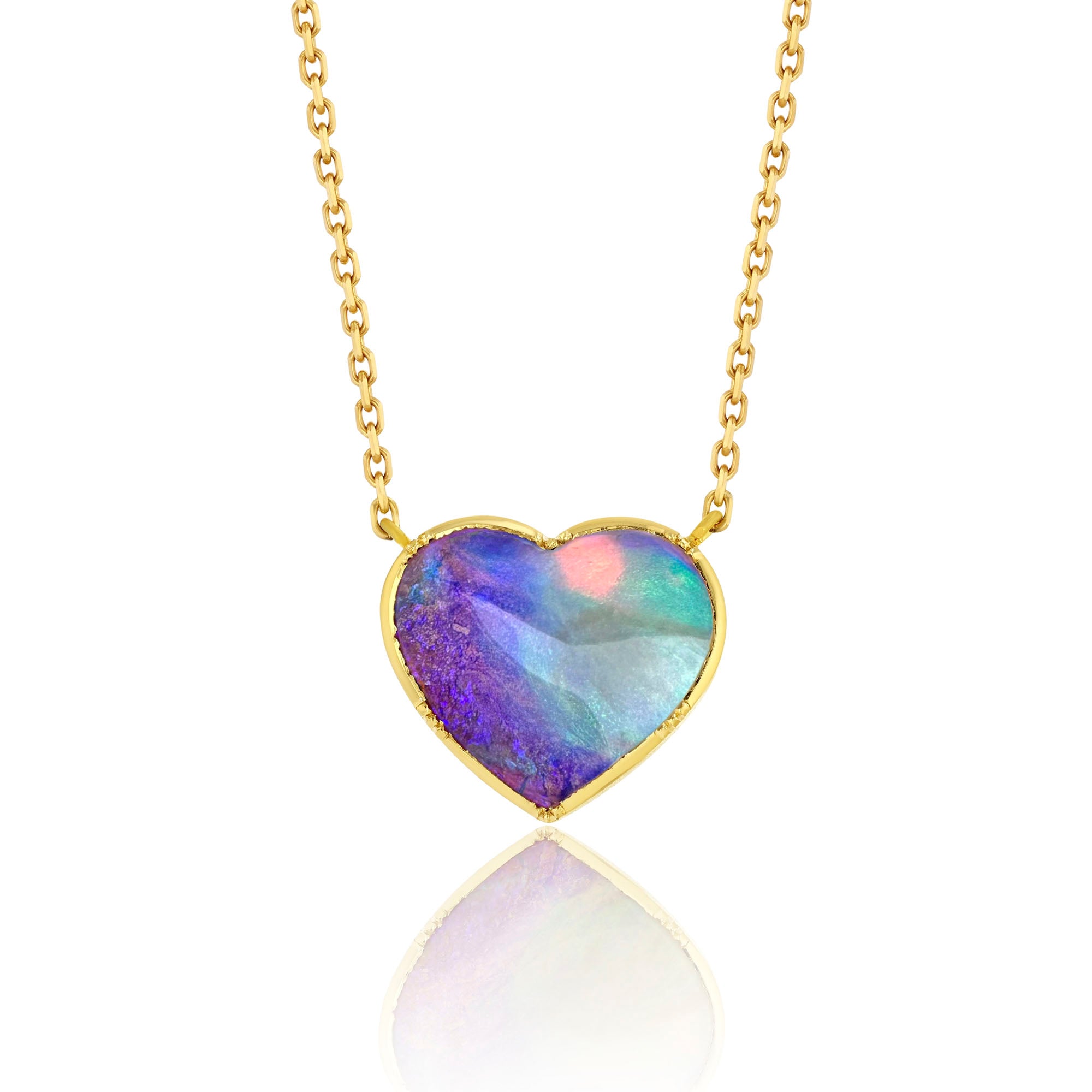 Heart-shaped opal pendant on a gold chain against a white background