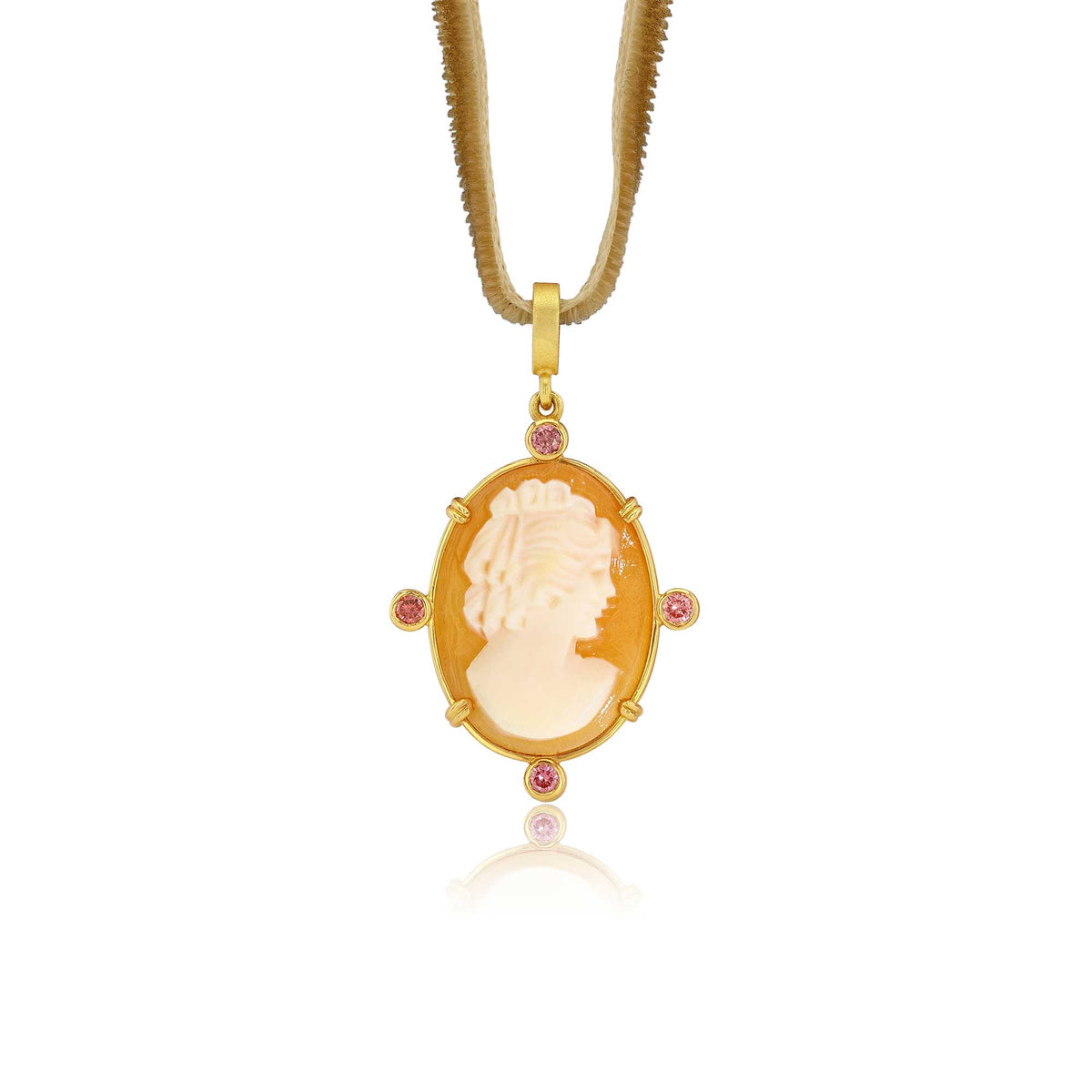 A gold pendant necklace featuring a carved cream-colored cameo-style profile in an oval frame, accented with four small pink tourmaline gemstones, suspended from a gold chain on a white background.