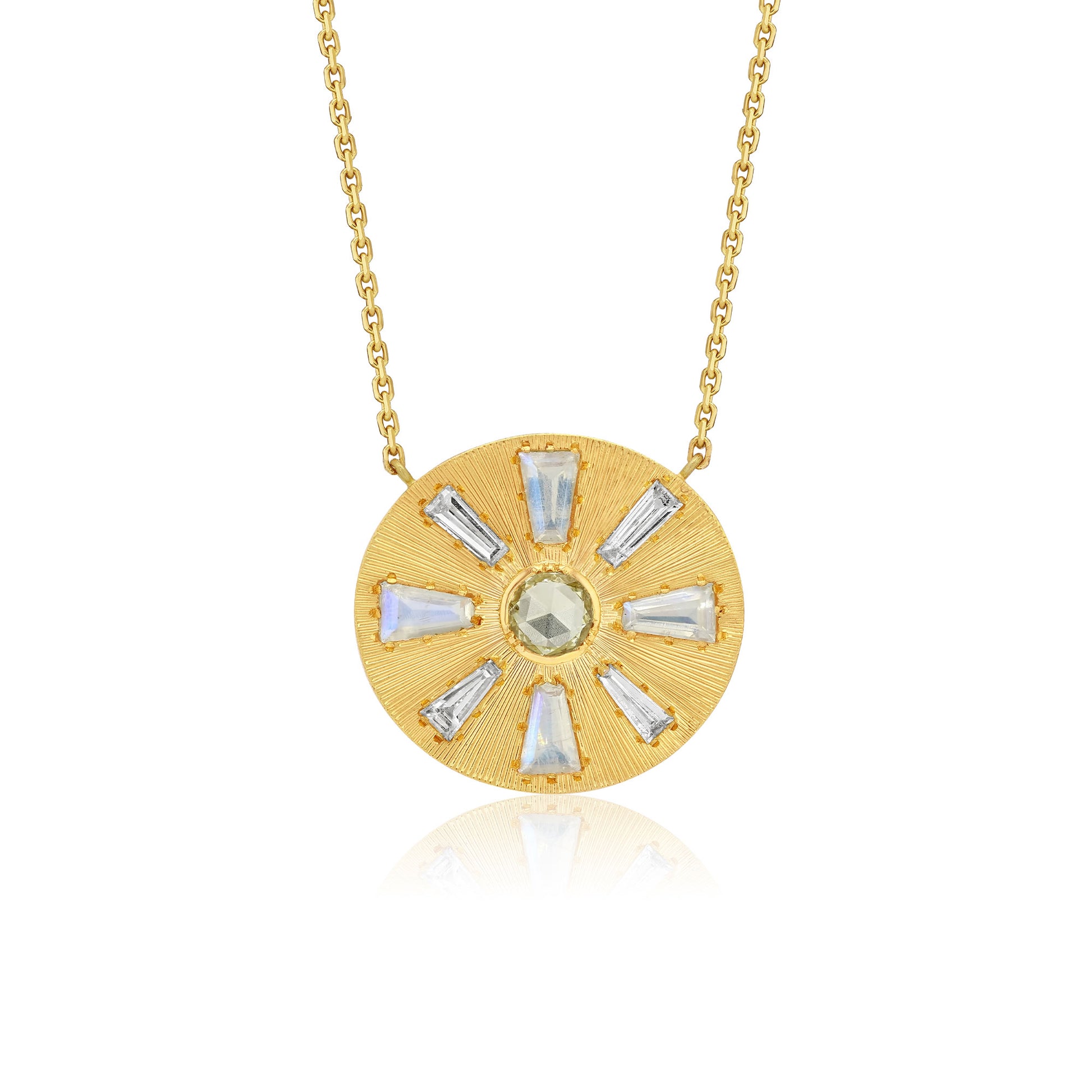 A gold circular pendant necklace featuring a sunburst design with clear baguette-cut diamond stones and a central round pale green diamond gemstone, suspended from a delicate gold chain against a white background.
