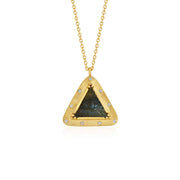 A gold triangle pendant necklace featuring a central dark green and black eye of providence labradorite motif, accented with small diamond stones along the border, suspended from a delicate gold chain against a white background.