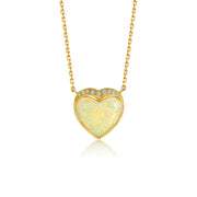 A gold heart pendant necklace featuring a milky white australian opal center stone with a halo of small diamond stones, shown on a clean white background.