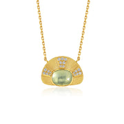 A gold pendant necklace featuring a fan-shaped design with a central oval light aquamarine green stone and small clear accent diamond stones, shown on a white background with a soft reflection.