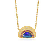 An 18k yellow gold pendant necklace featuring a semi-circular sunburst hand engraved design with a central blue boulder opal accented by small purple  garnet gemstones and tiny diamond stones, shown on a white background.