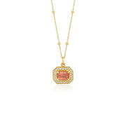 Gold pendant with a central rhodochrosite gemstone with white diamond pave detailing on a white background