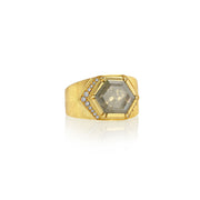 18k gold ring with a large hexagonal raw diamond gemstone and smaller stones on a white background.