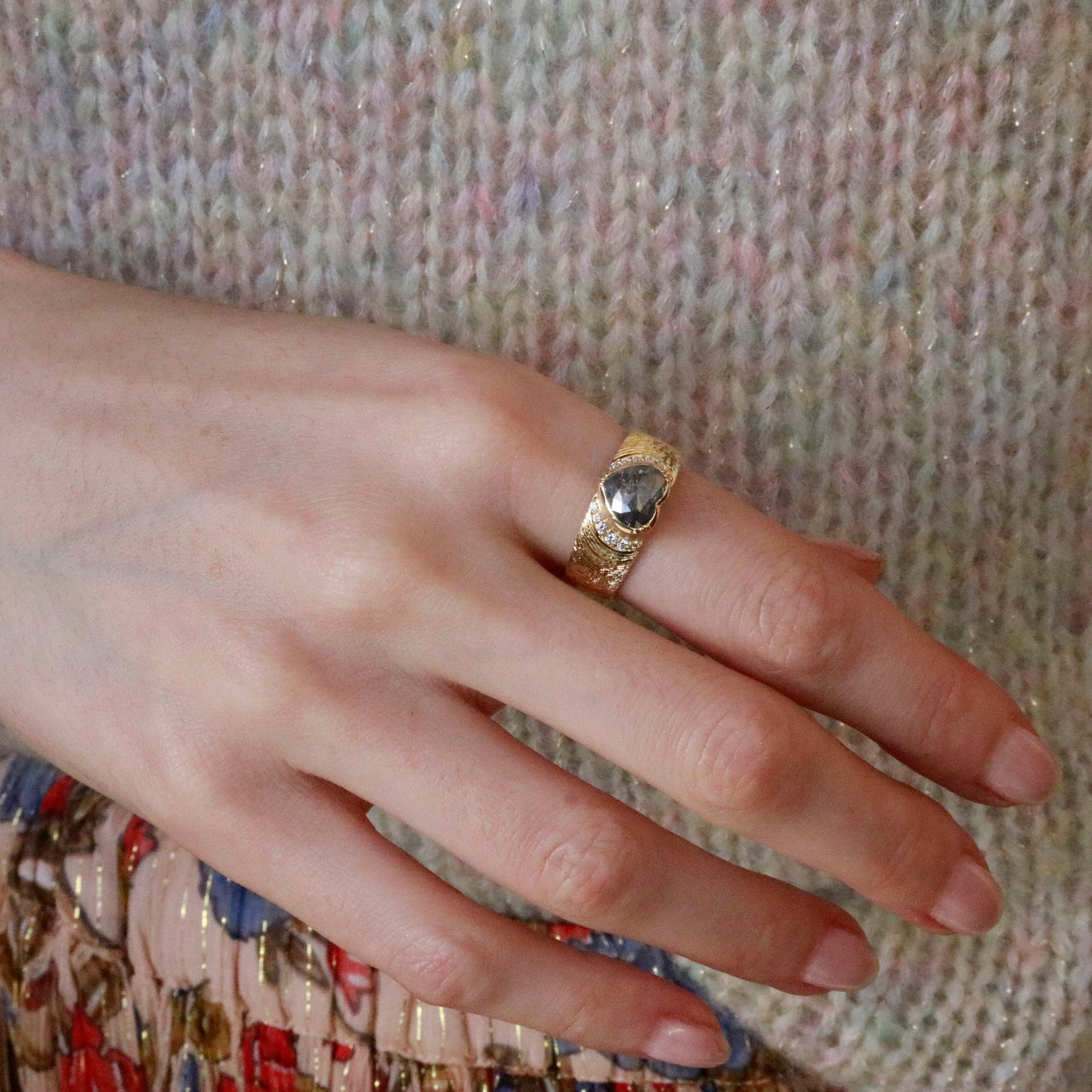 Model wearing unique 18k gold heart-shaped diamond ring with diamond pave and hand engraved  band from Los Angeles designer Brooke Gregson