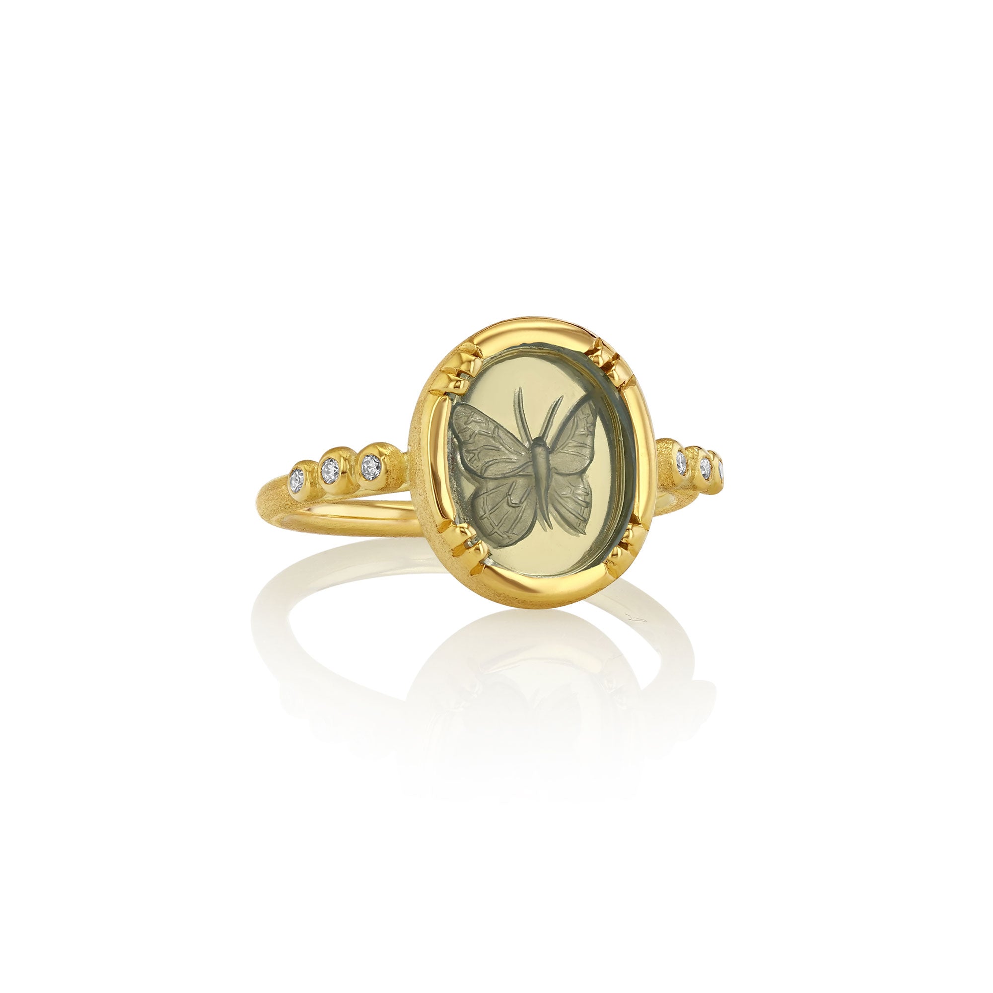18k gold ring with topaz stone butterfly design on a white background