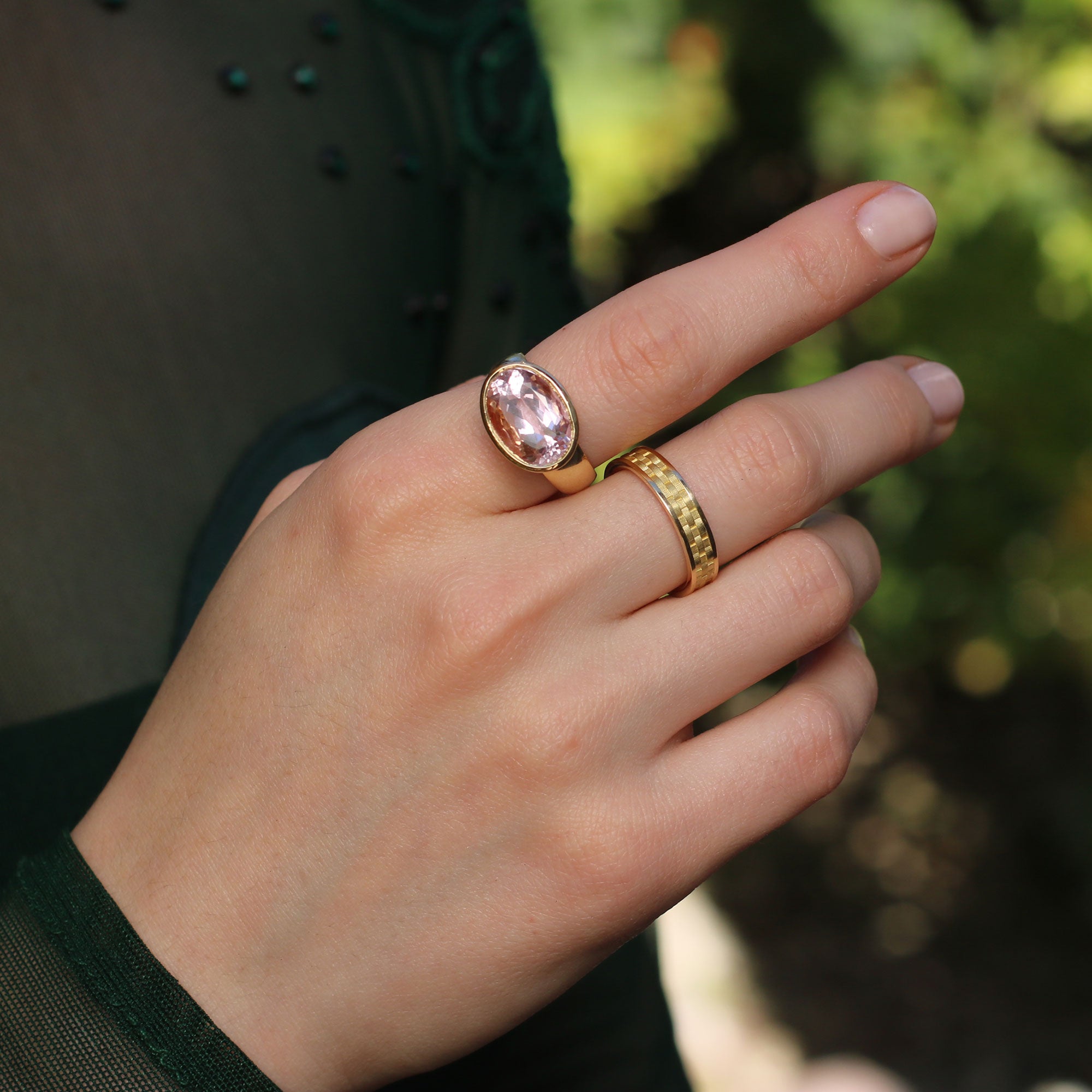 Model wearing 18k gold rings, kunzite ring with basket weave engraved setting and basket weave gold band ring from Los Angeles jewelry designer Brooke Gregson