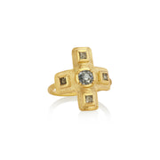 Gold cross ring with raw diamond accents on a white background