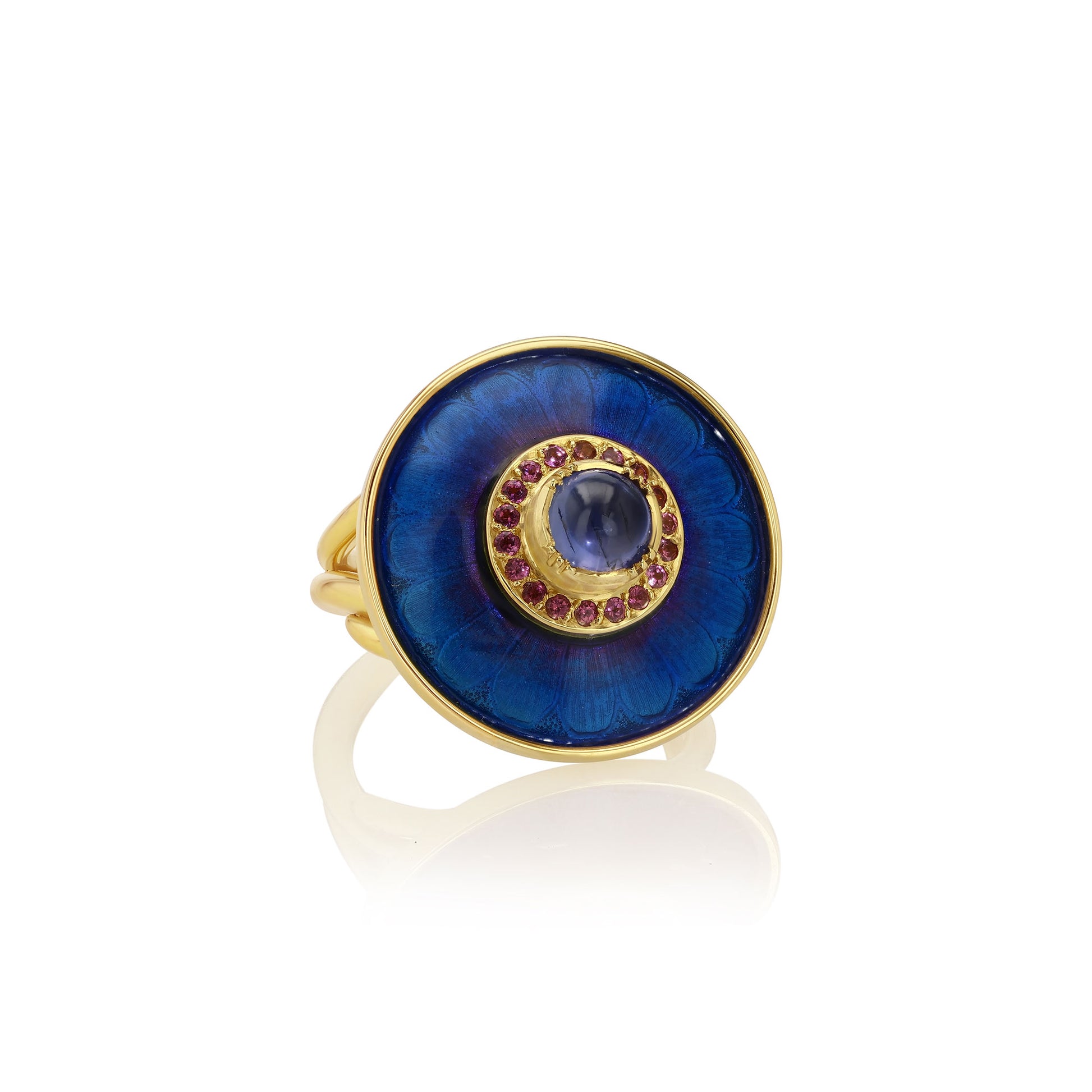 Gold ring with a blue sapphire stone and garnet gemstones with blue enamel work on a white background