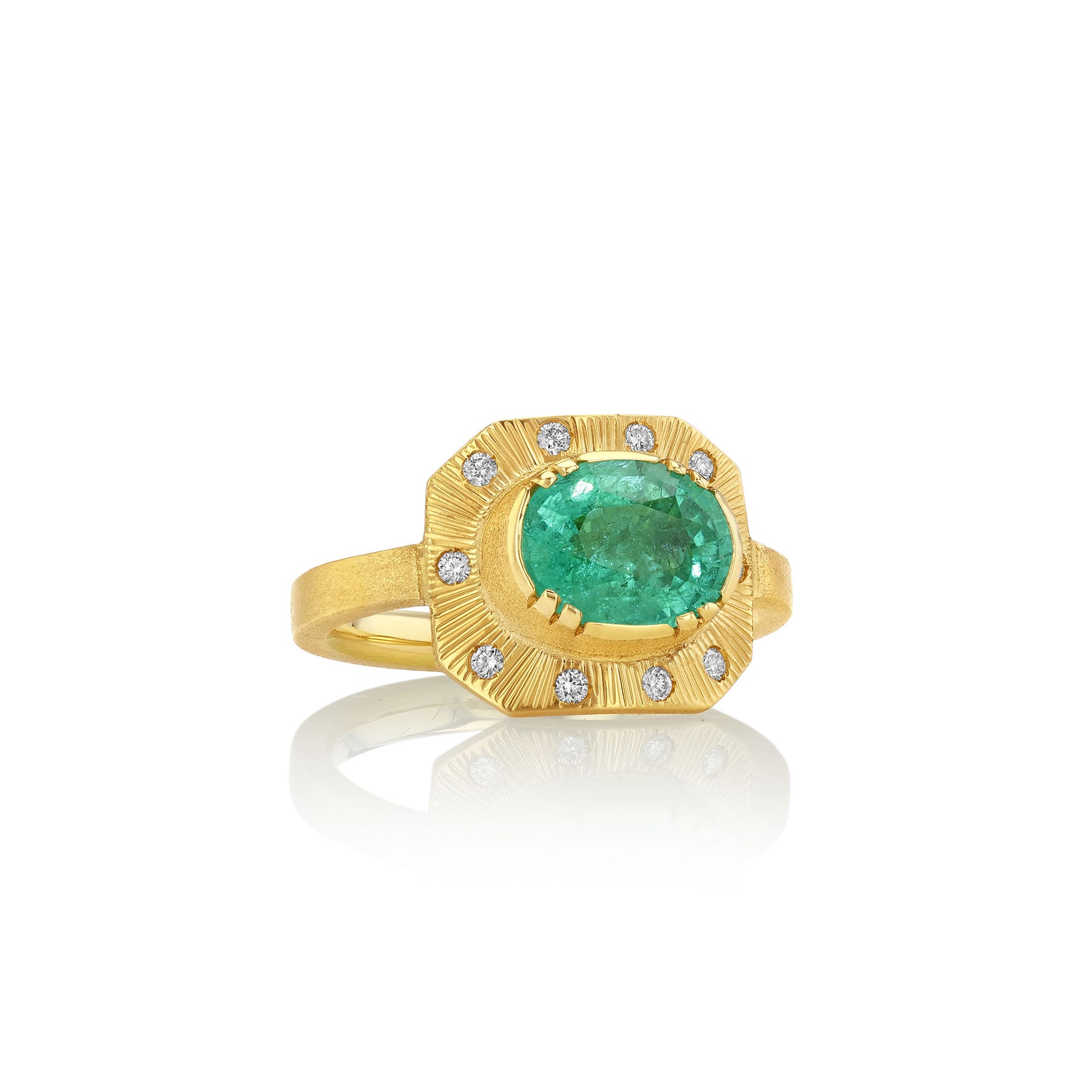 Gold ring with a green gemstone and small diamonds on a white background