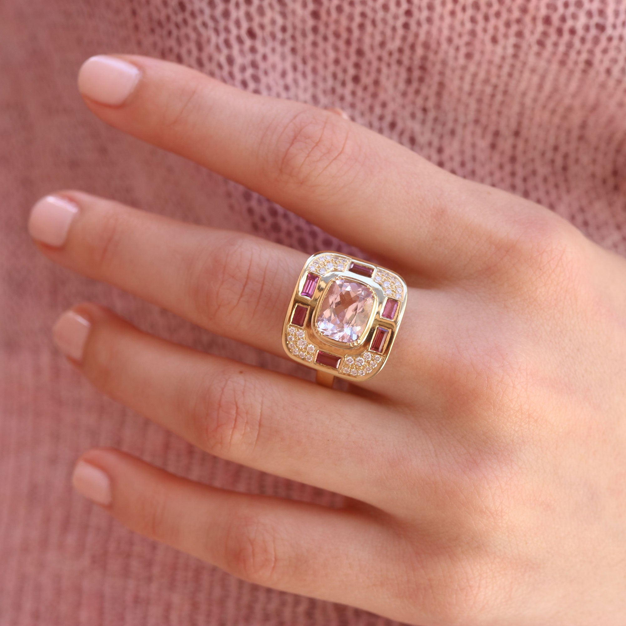 Model wearing one of a kind Morganite, Ruby and Diamond ring from fine jewelry designer Brooke Gregson handmade in London
