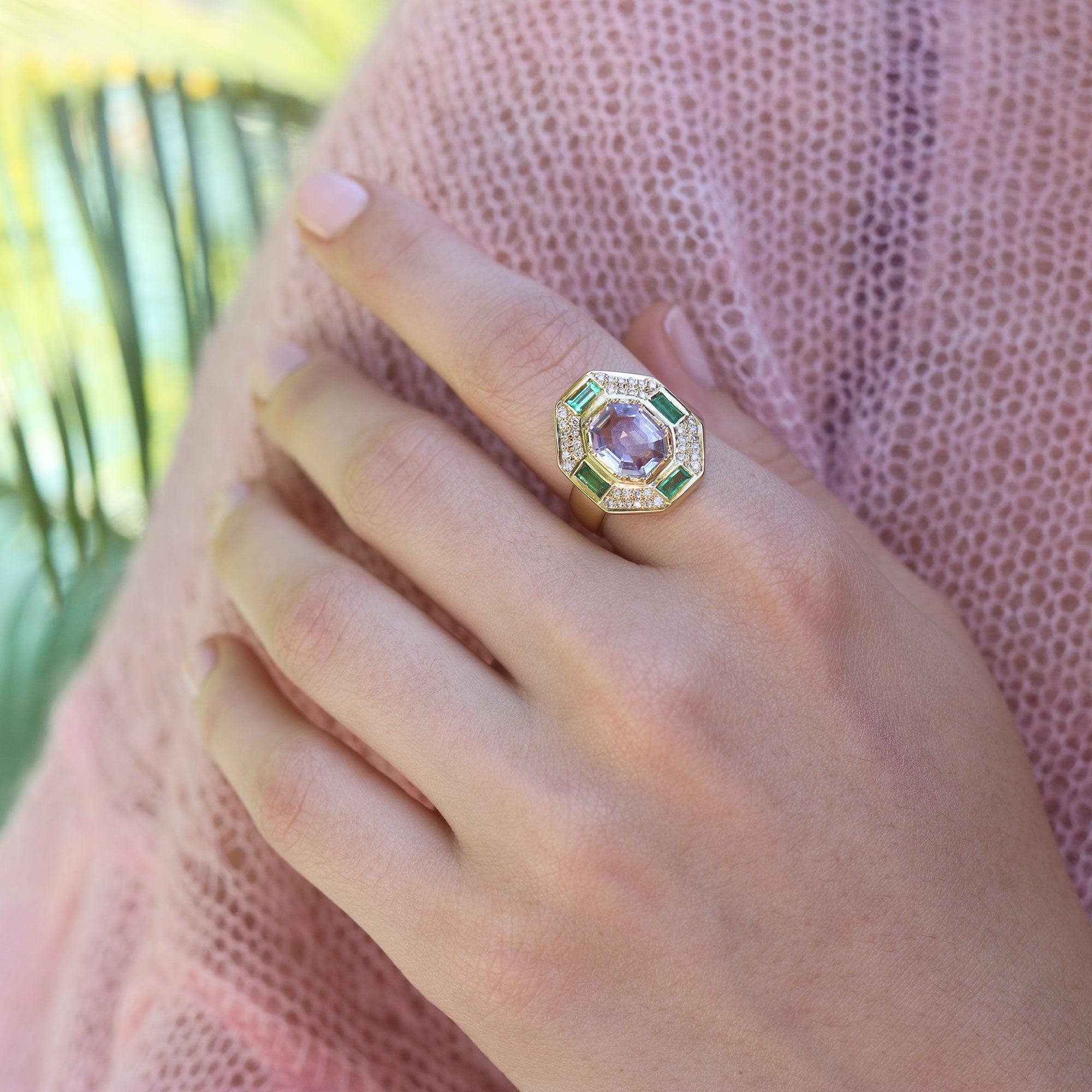 Model wearing one of a kind Morganite, Emerald and Diamond ring from fine jewelry designer Brooke Gregson, handmade in London.