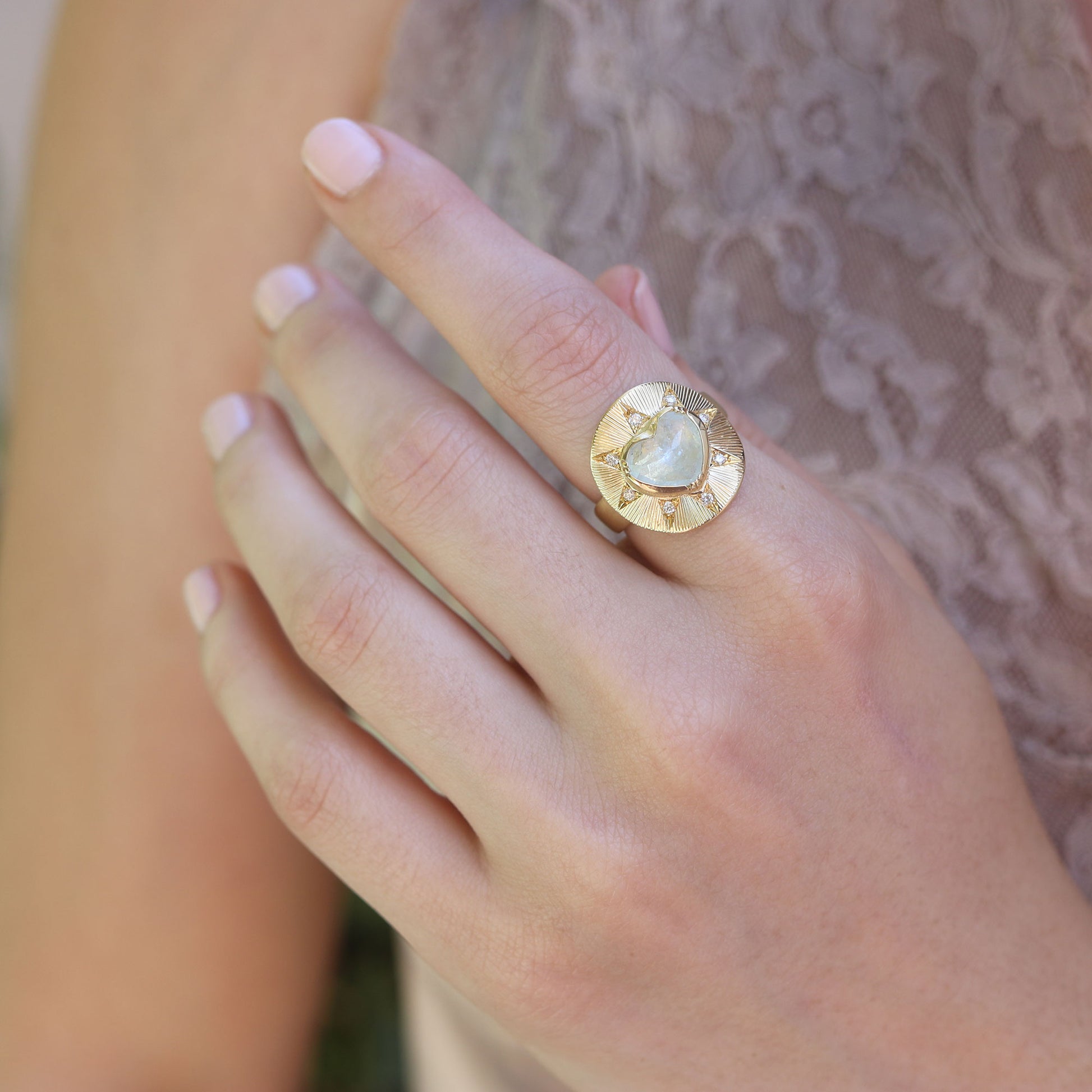 Model wearing one of a kind 18k gold engraved Aquamarine and Diamond ring from fine jewelry designer Brooke Gregson handmade in London