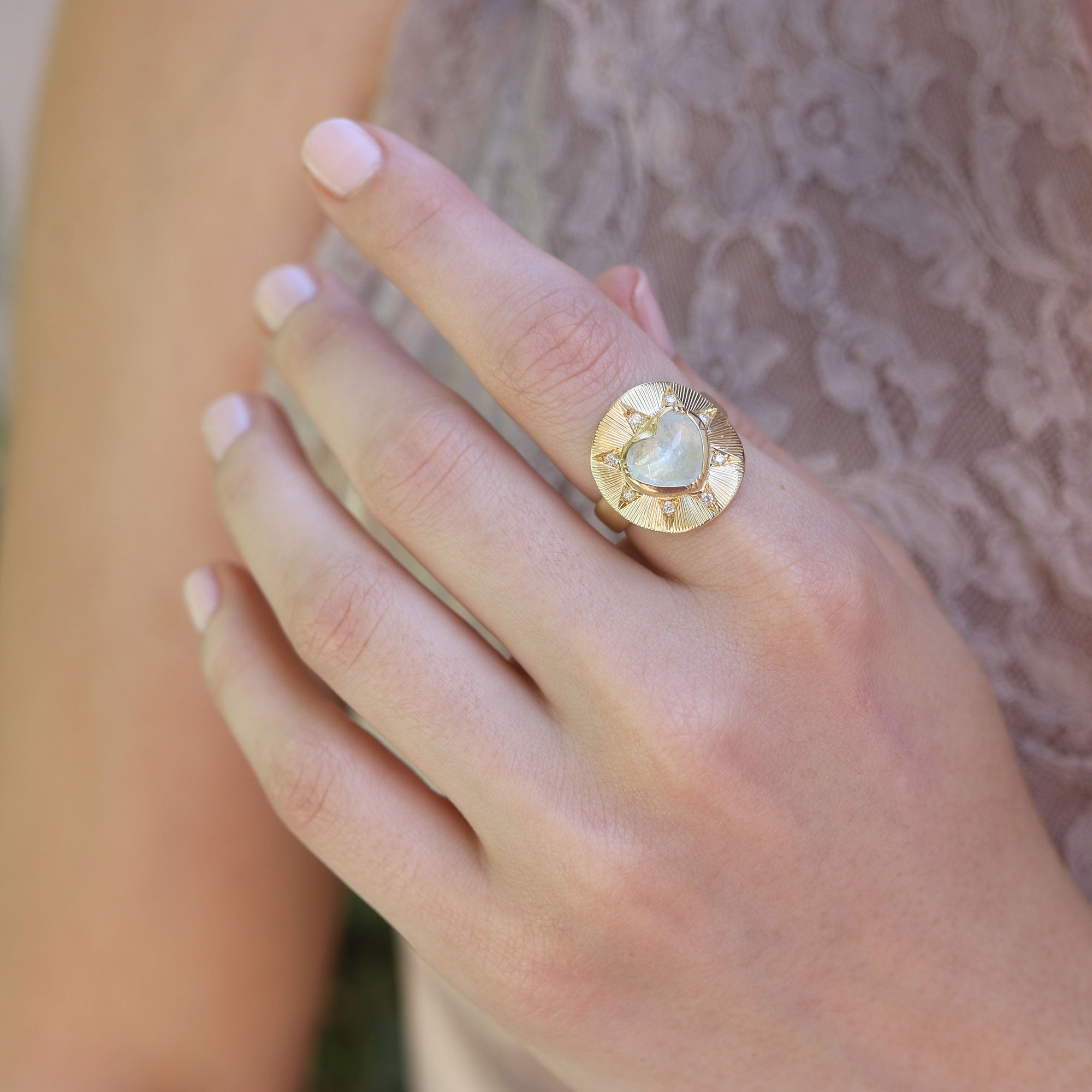 Model wearing one of a kind 18k gold engraved Aquamarine and Diamond ring from fine jewelry designer Brooke Gregson handmade in London