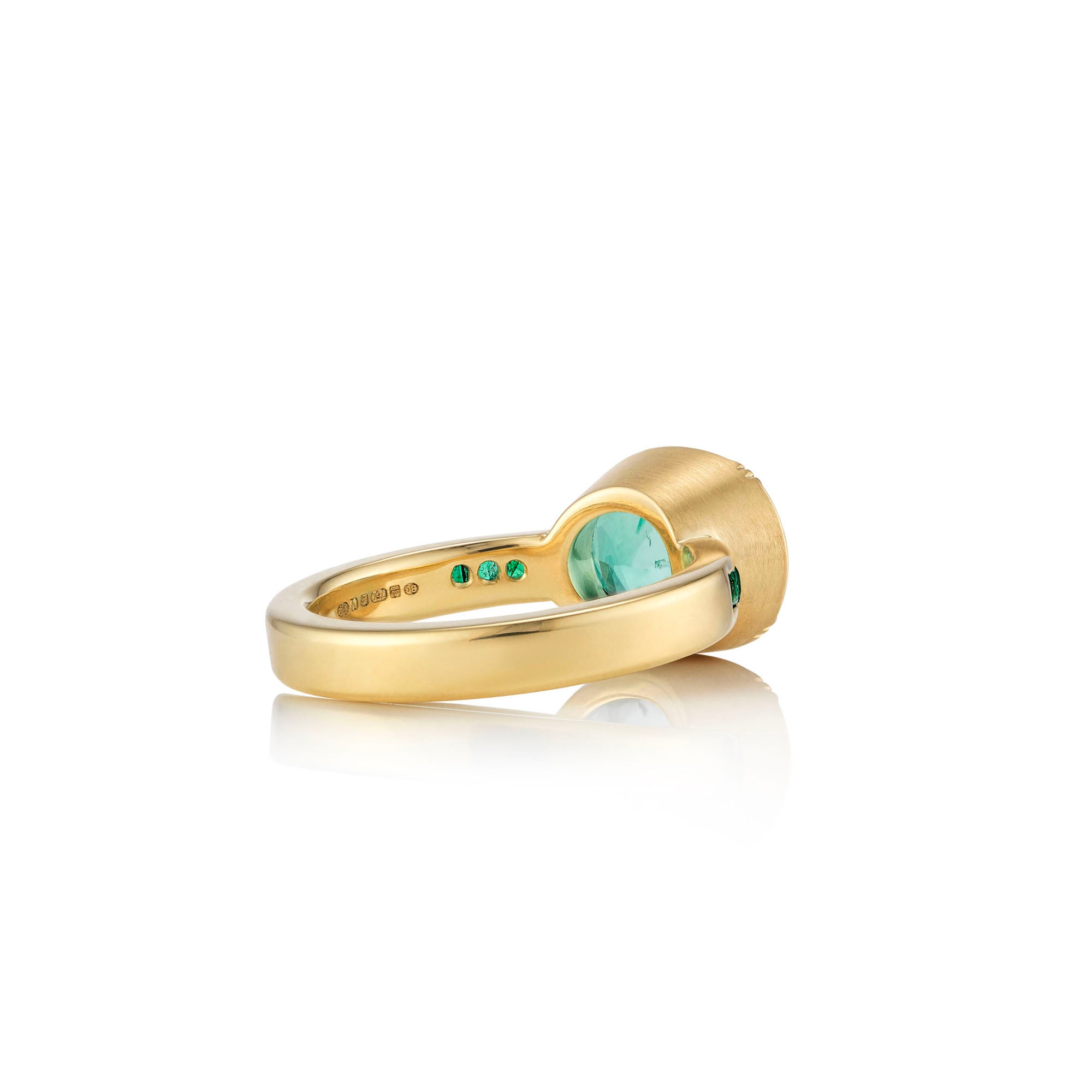 Three quarter view one of a kind 18k gold ring with large emerald centre and emerald band detail from Los Angeles jewelry designer Brooke Gregson