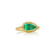 A gold ring featuring a large pear-cut green emerald center stone, accented by small clear pavé diamonds along the band, shown on a white background with a soft reflection.