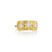 Gold ring with three hexagonal diamond stones on a white background