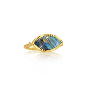 A gold ring featuring a marquise-shaped iridescent boulder opal stone with blue, green, and orange flashes, set in a gold bezel on a white background with a soft reflection.