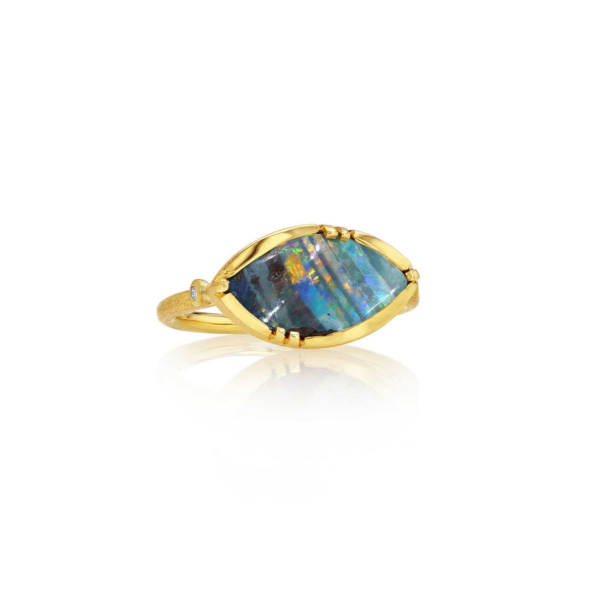 A gold ring featuring a marquise-shaped iridescent boulder opal stone with blue, green, and orange flashes, set in a gold bezel on a white background with a soft reflection.