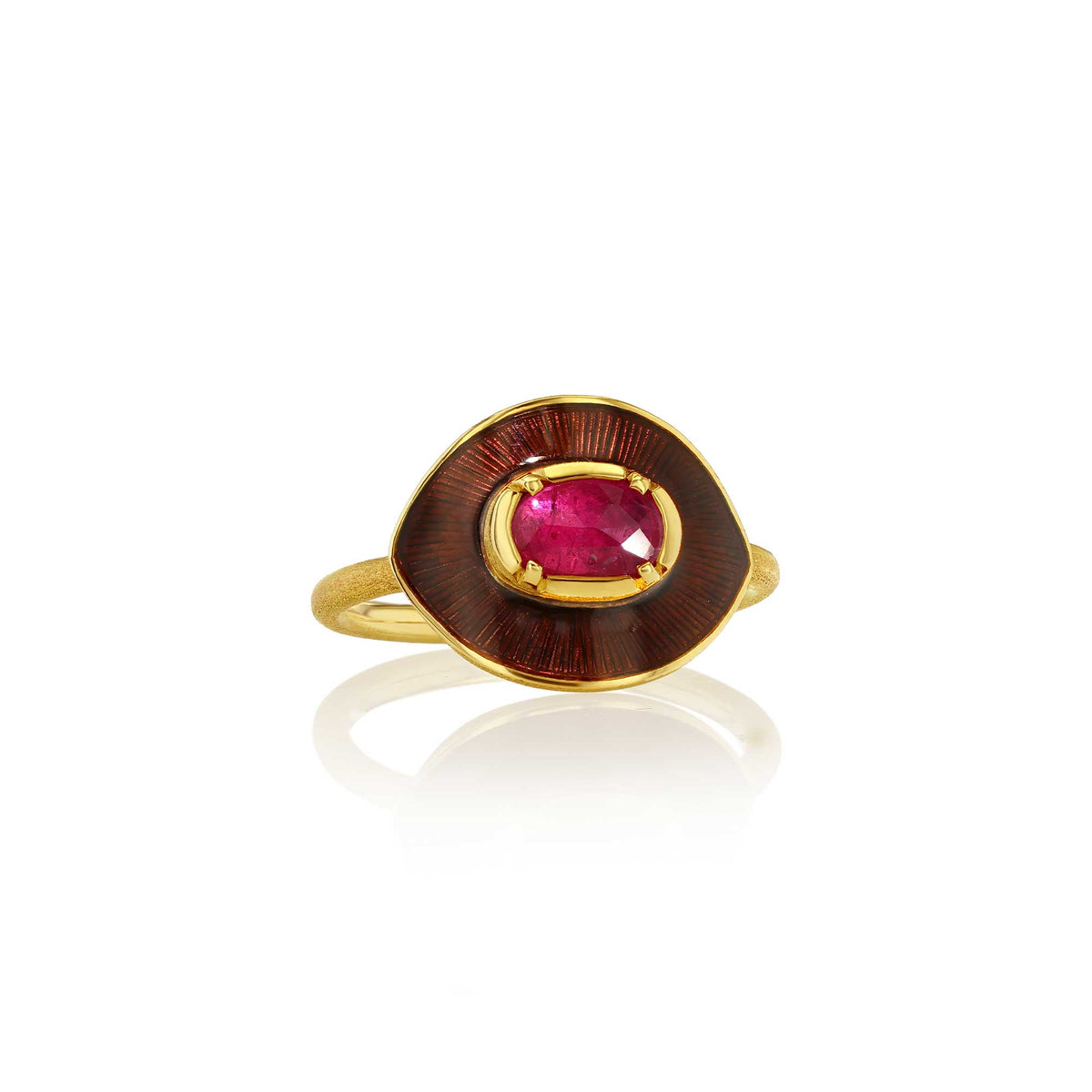 A gold ring featuring a large, scalloped dark reddish-brown enamel inlay and a central oval pink ruby gemstone, shown on a clean white background with a soft reflection.