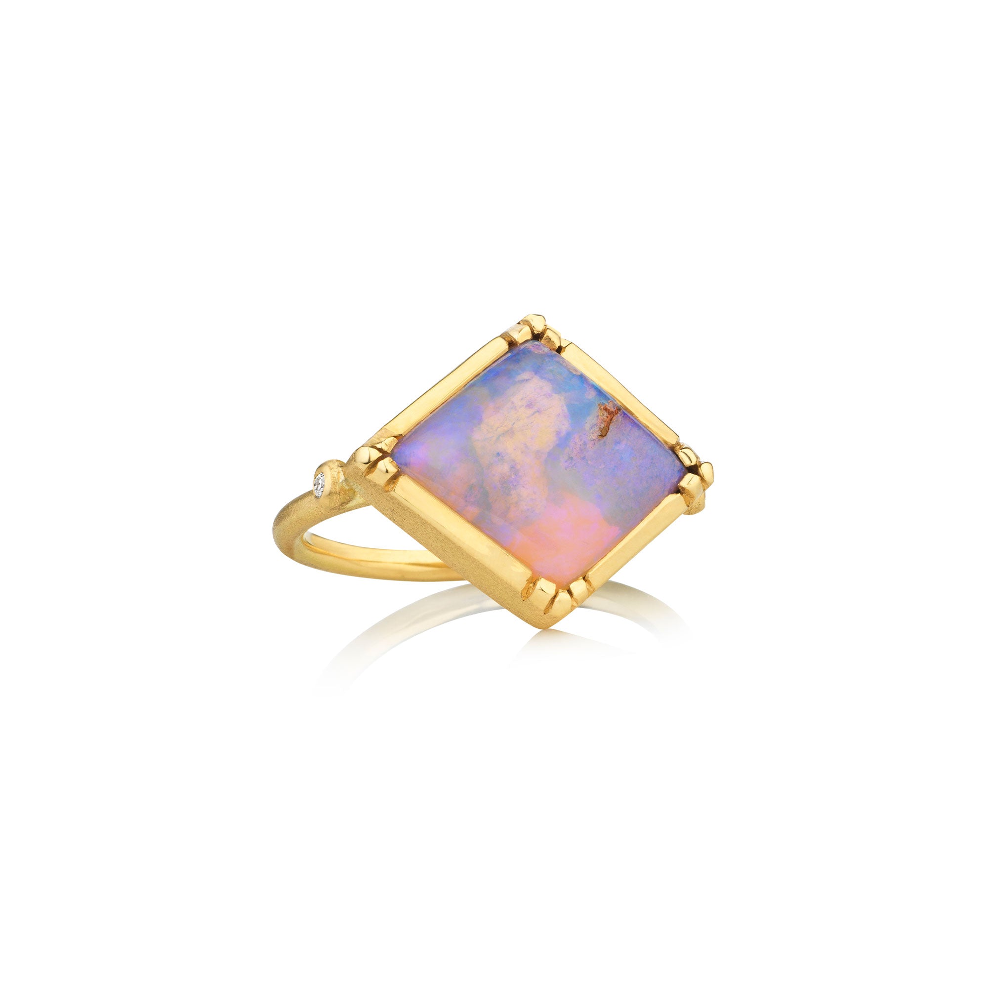 gold ring with opal gemstone on white background