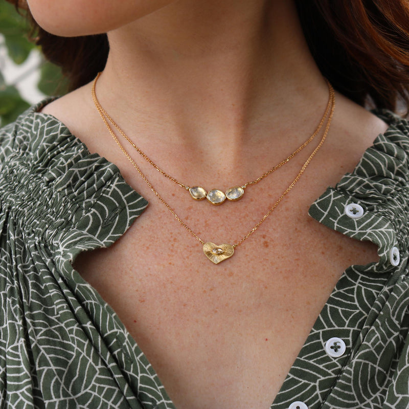 Model wearing Hand made in London Brooke Gregson 18k gold engraved heart diamond necklace